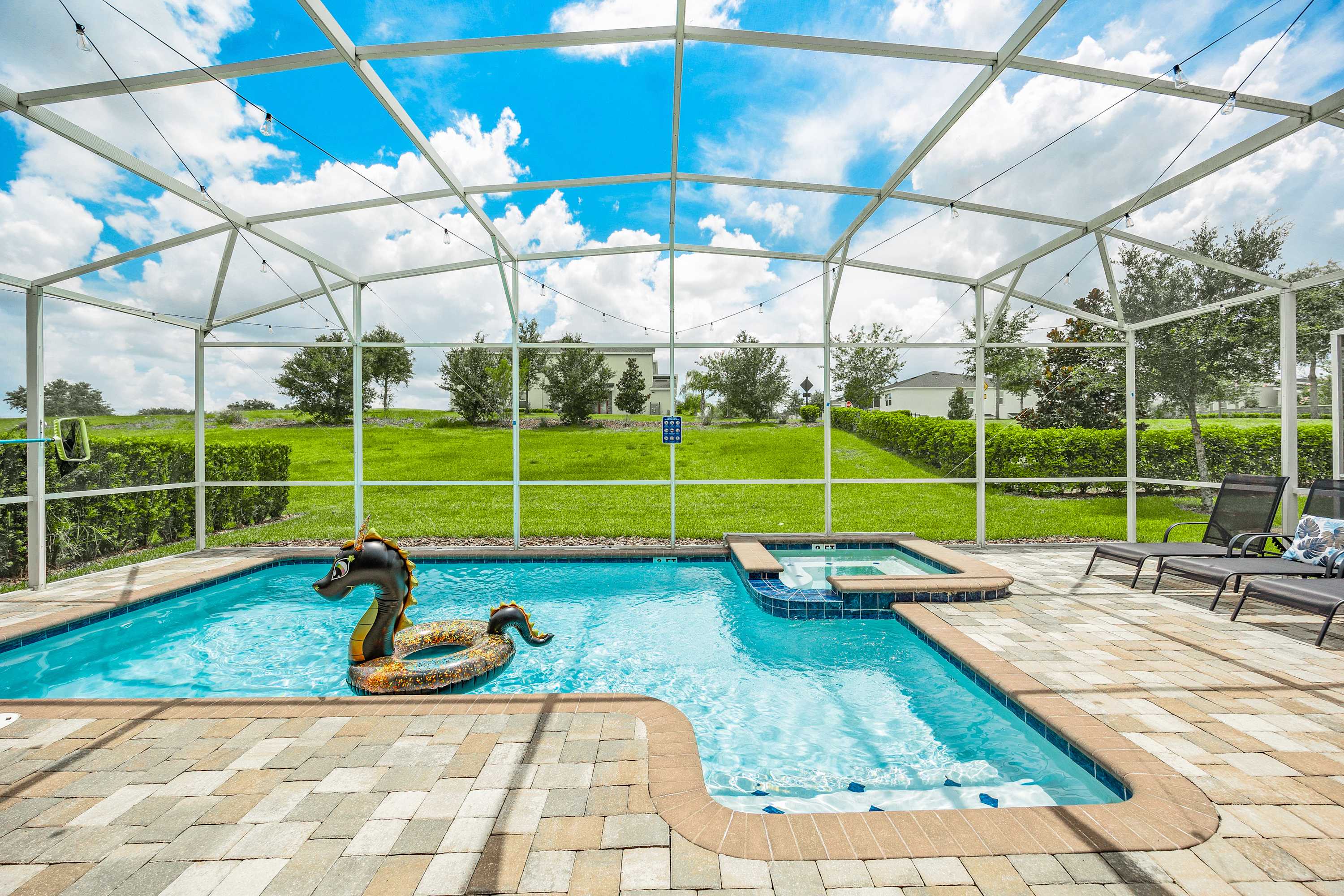 Resort-style pool area with lounge space, perfect for relaxing and enjoying the sun.