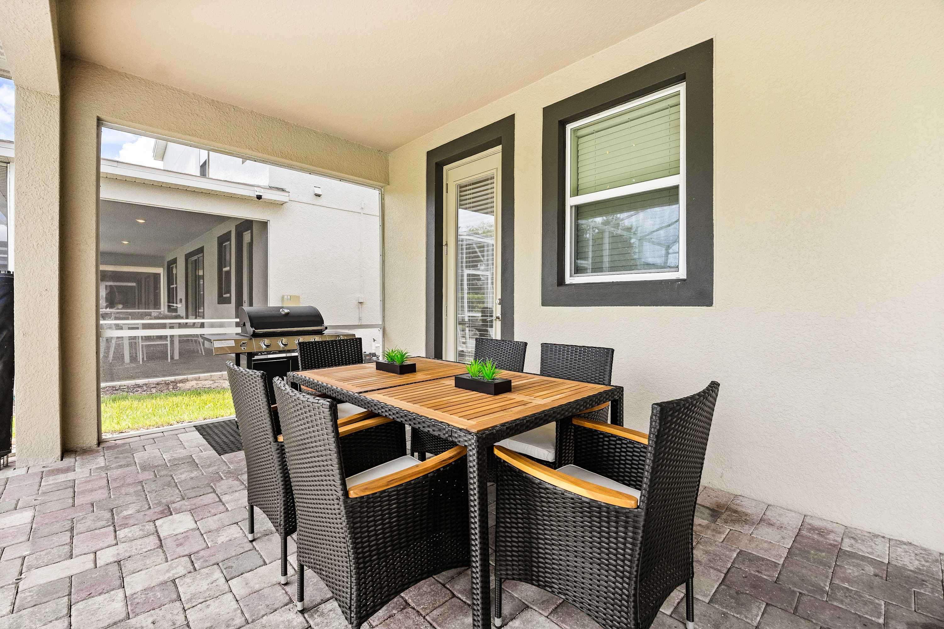 Outdoor dining area with seating and grill, perfect for meals and gatherings.