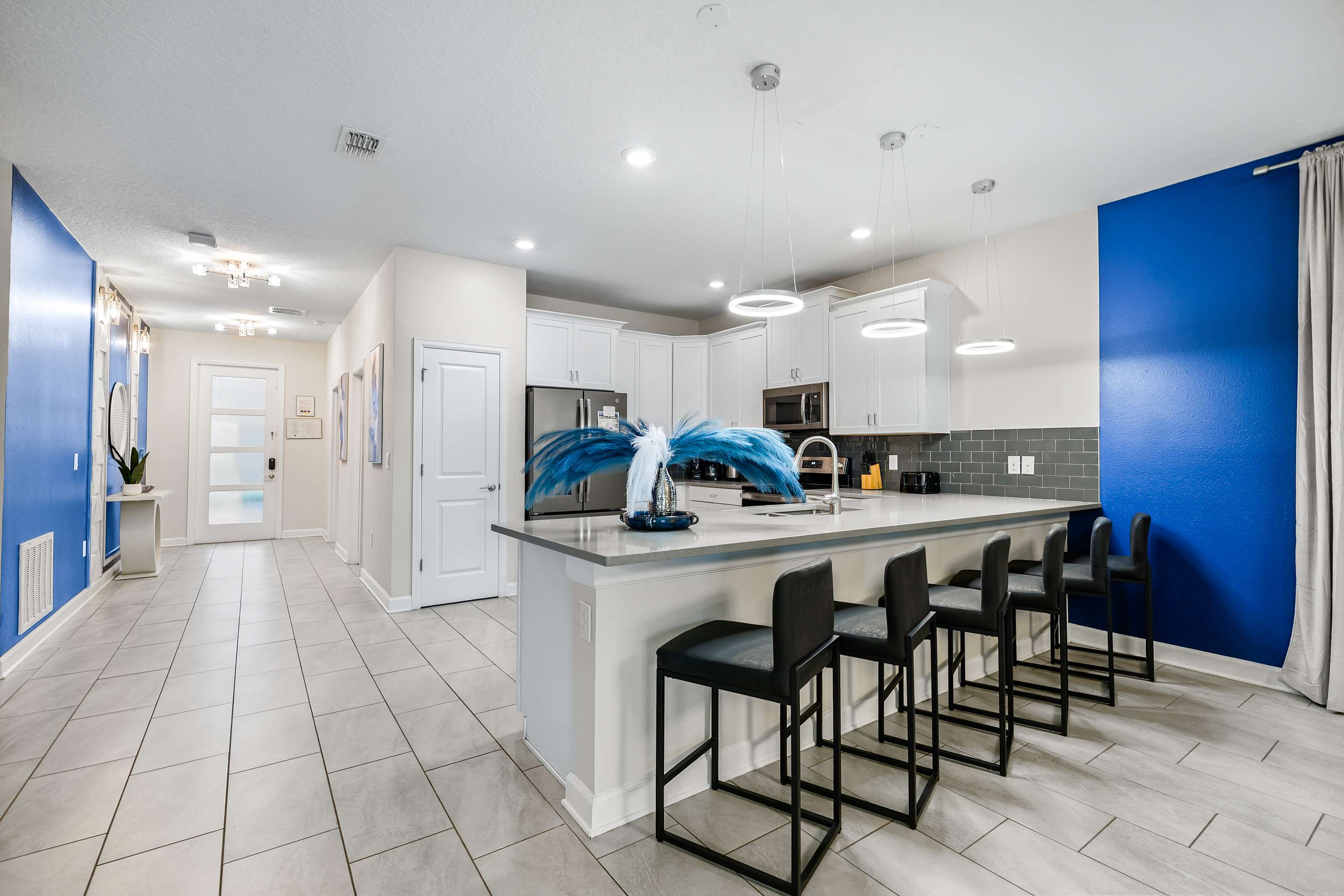 Modern open kitchen with island seating and fully equipped for your stay.