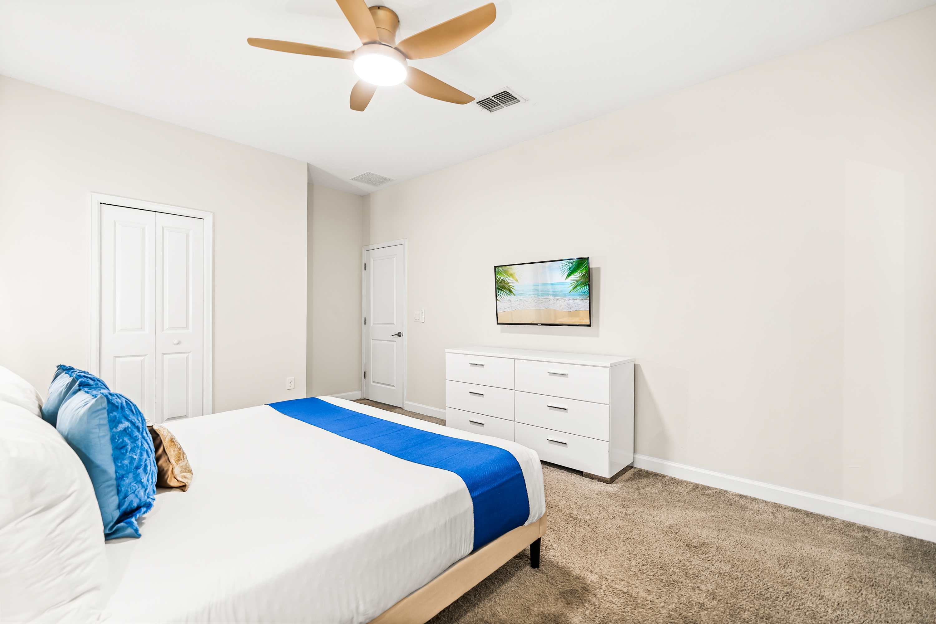 Bright and airy master bedroom with comfortable bedding and minimalist layout.