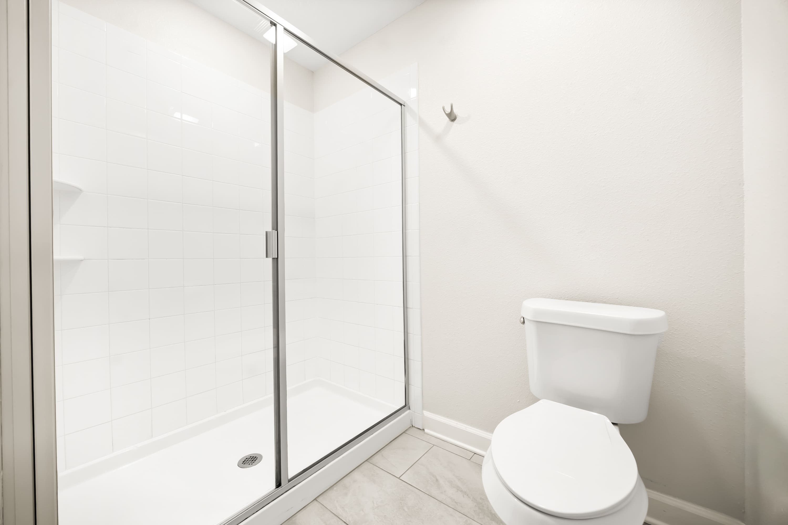 Full bathroom with glass-enclosed shower and clean finishes.