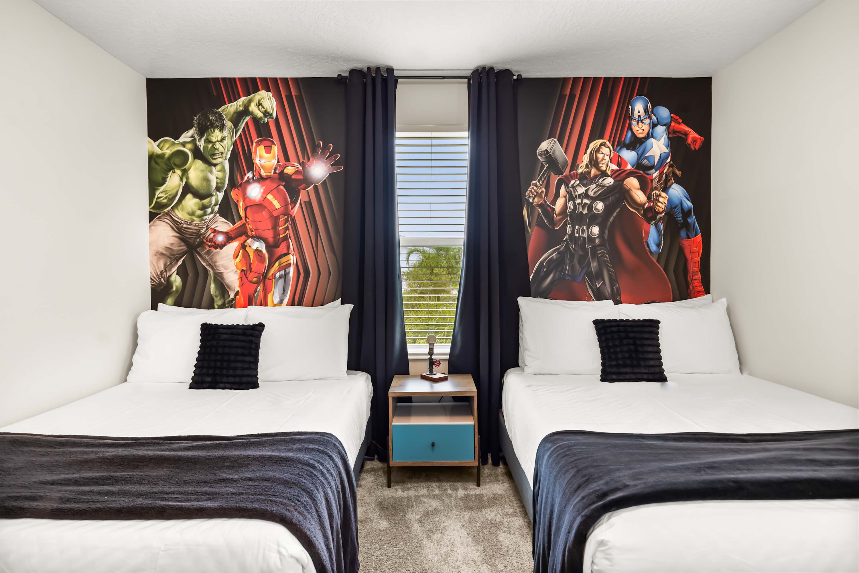 Dual beds setup with iconic Avengers artwork, a fun and immersive stay for fans.