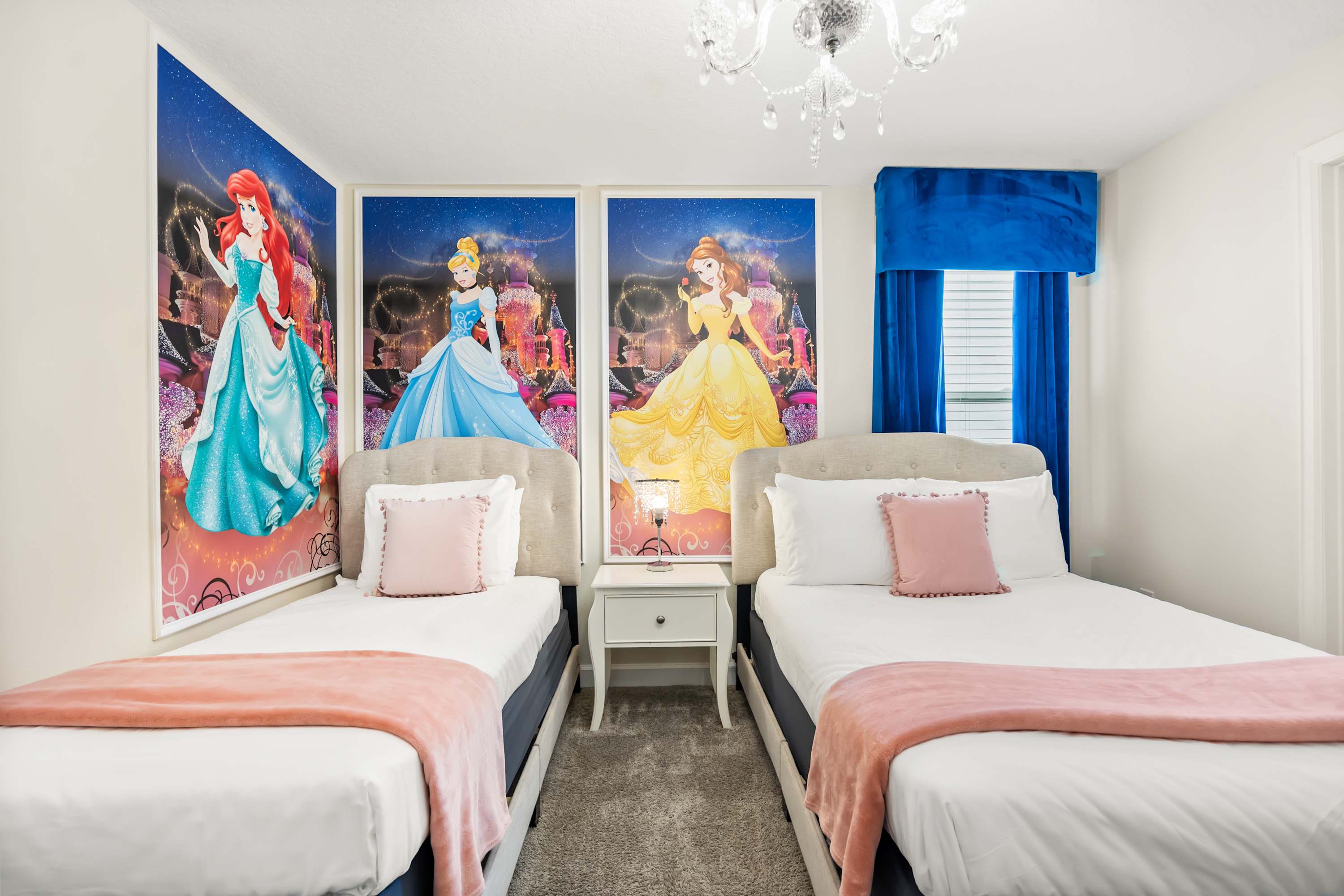 Twin beds with iconic princess artwork, a colorful and magical space for kids.
