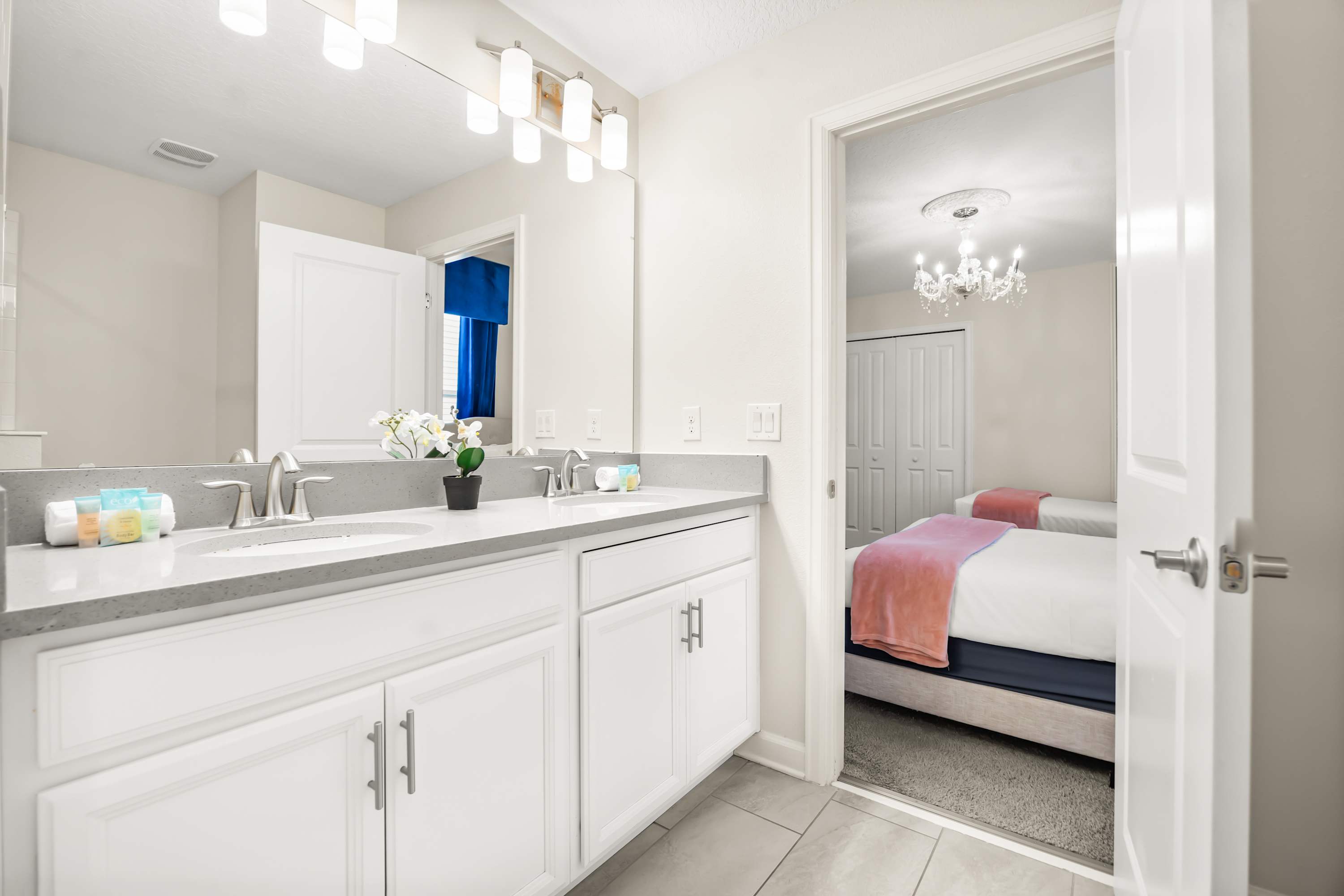 nsuite bathroom with double vanity and convenient access from the bedroom.