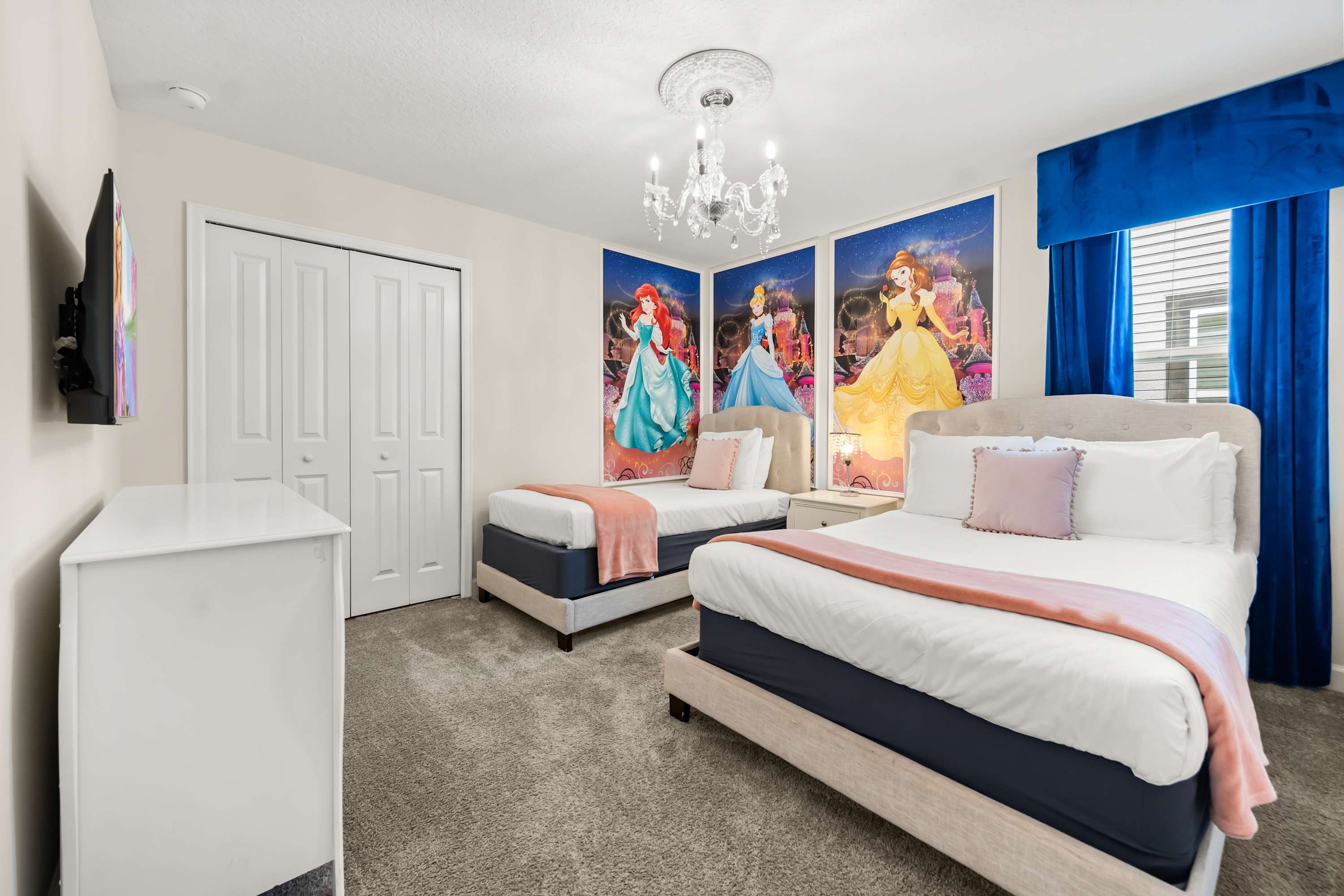 Princess-themed bedroom with two beds and colorful decor, perfect for a magical stay.
