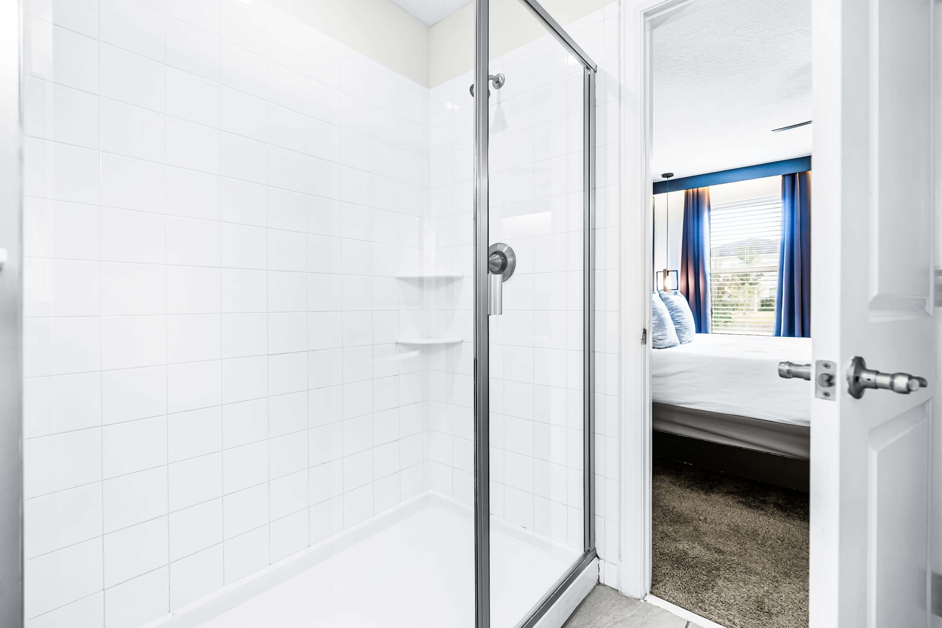 Full bathroom with glass shower and clean, modern finishes.