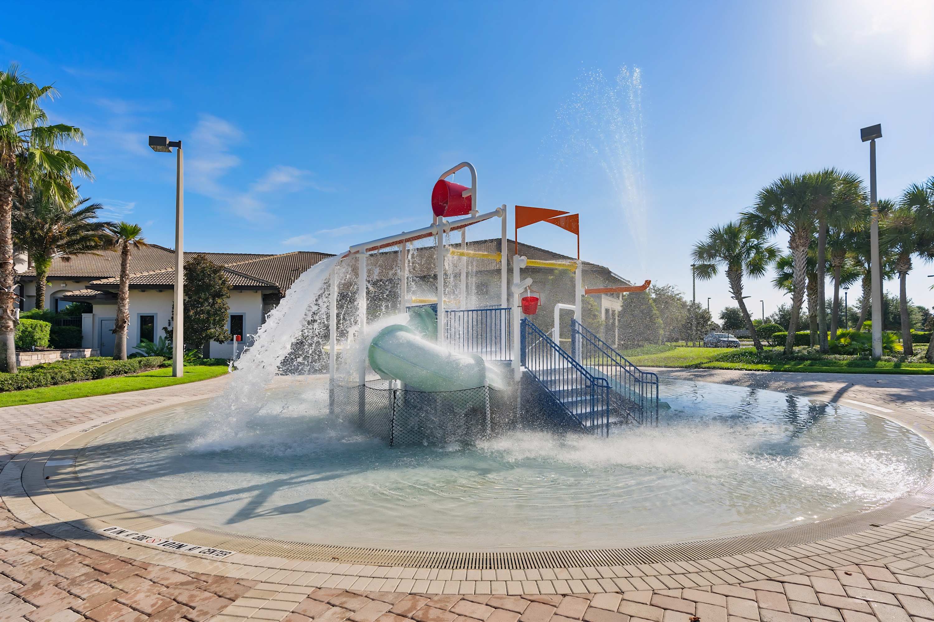 Water play area with slides and splash zone, fun for all ages.
