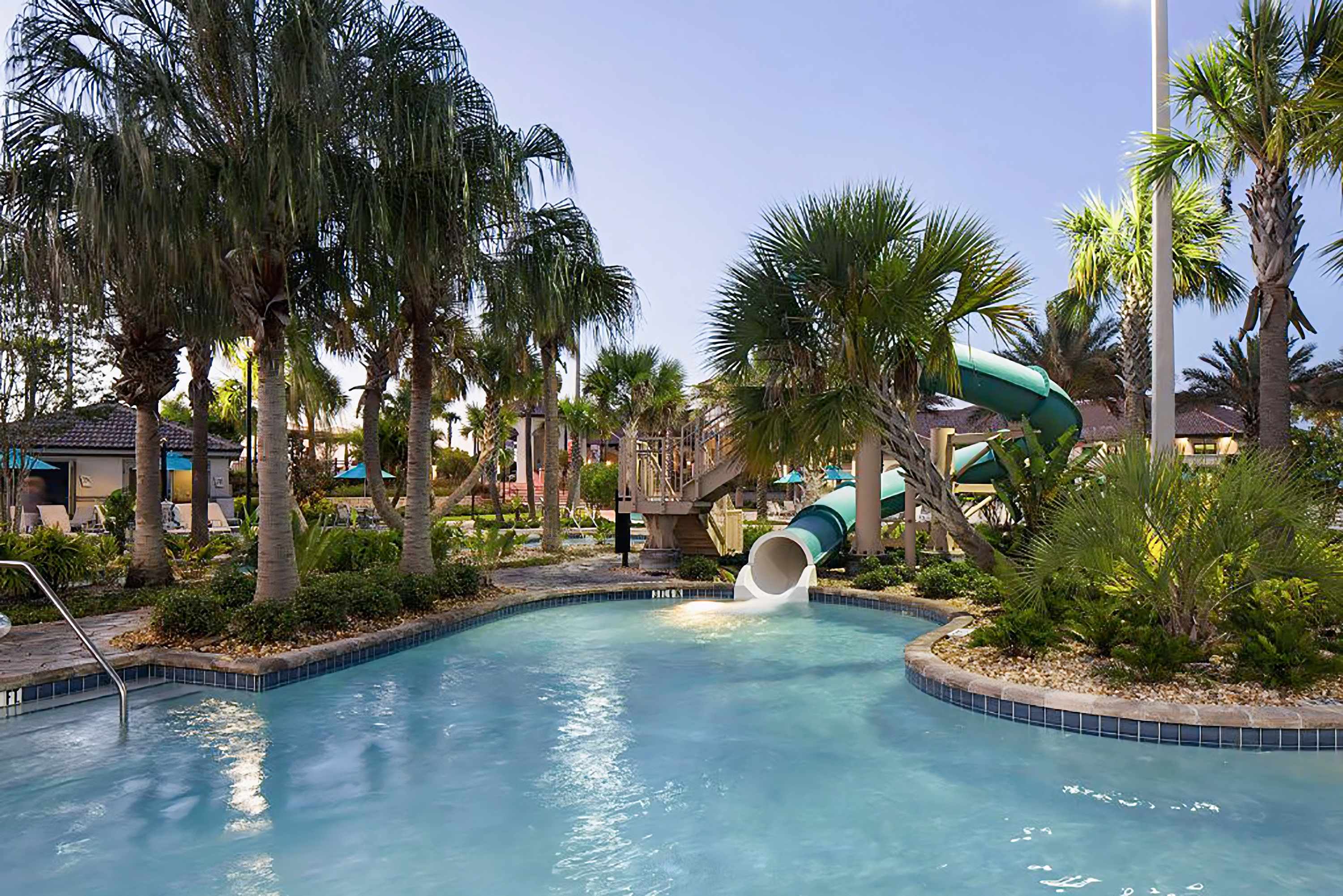 Resort-style lazy river surrounded by tropical landscaping, perfect for relaxing.
