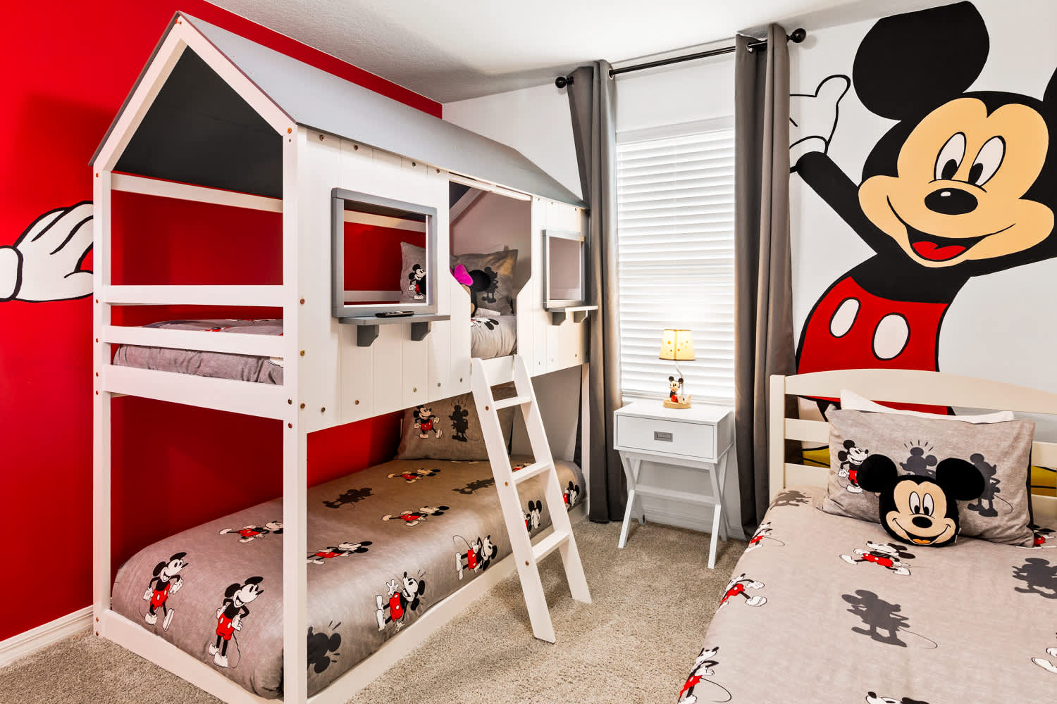 Delight your kids with this enchanting Mickey Mouse-themed room, complete with a playhouse bunk bed and vibrant decor!