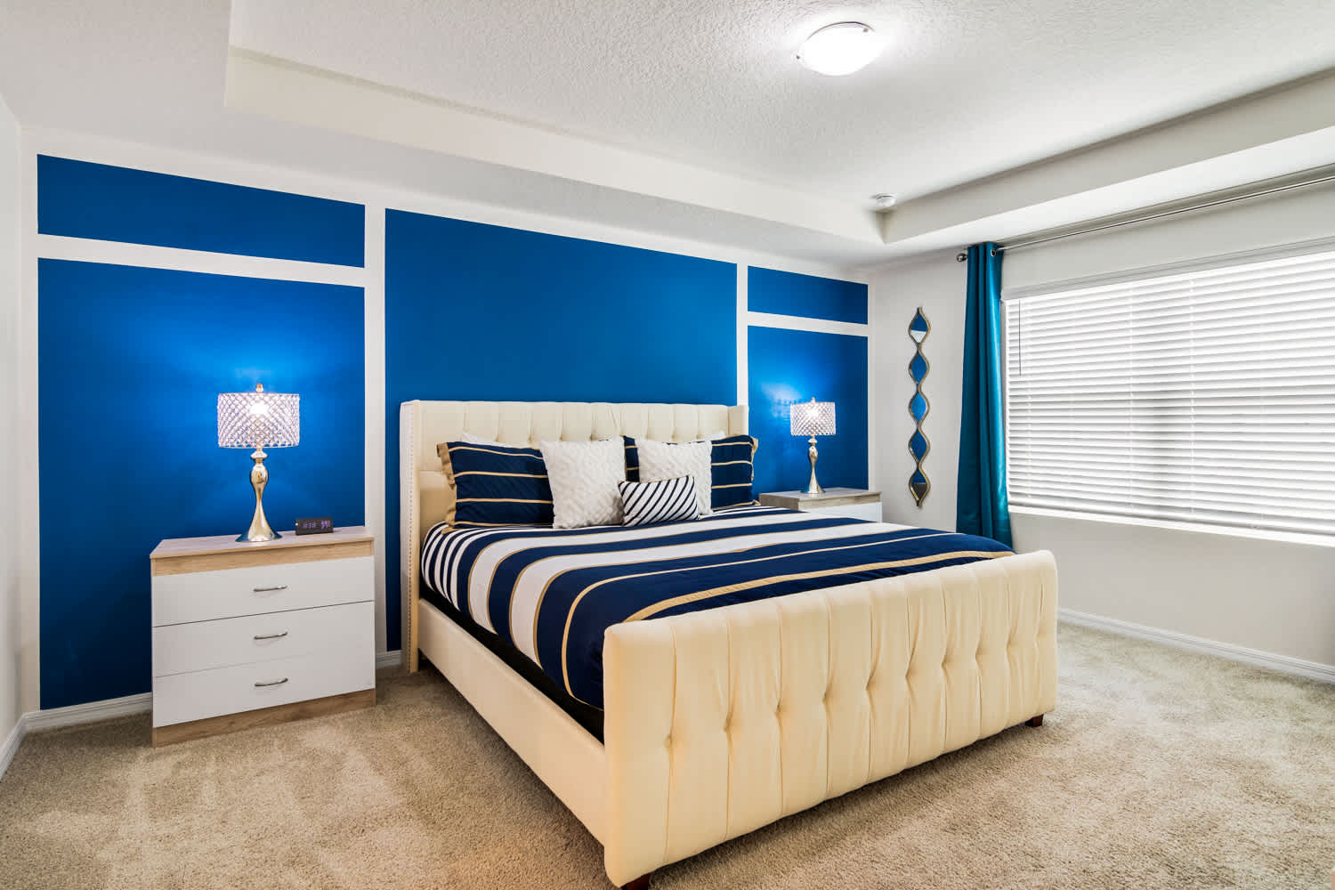 Relax in this stylish bedroom with a plush king-size bed and vibrant decor, perfect for a restful night's sleep.