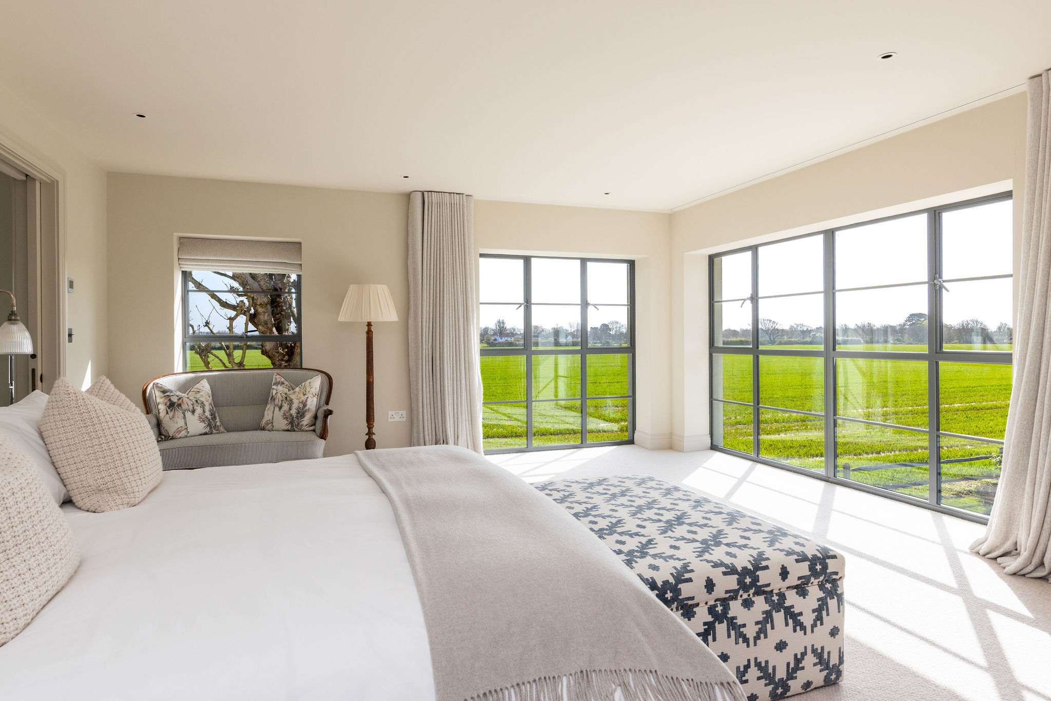 Wake up to sweeping green views in a luxurious super king bedroom with quality linens.
