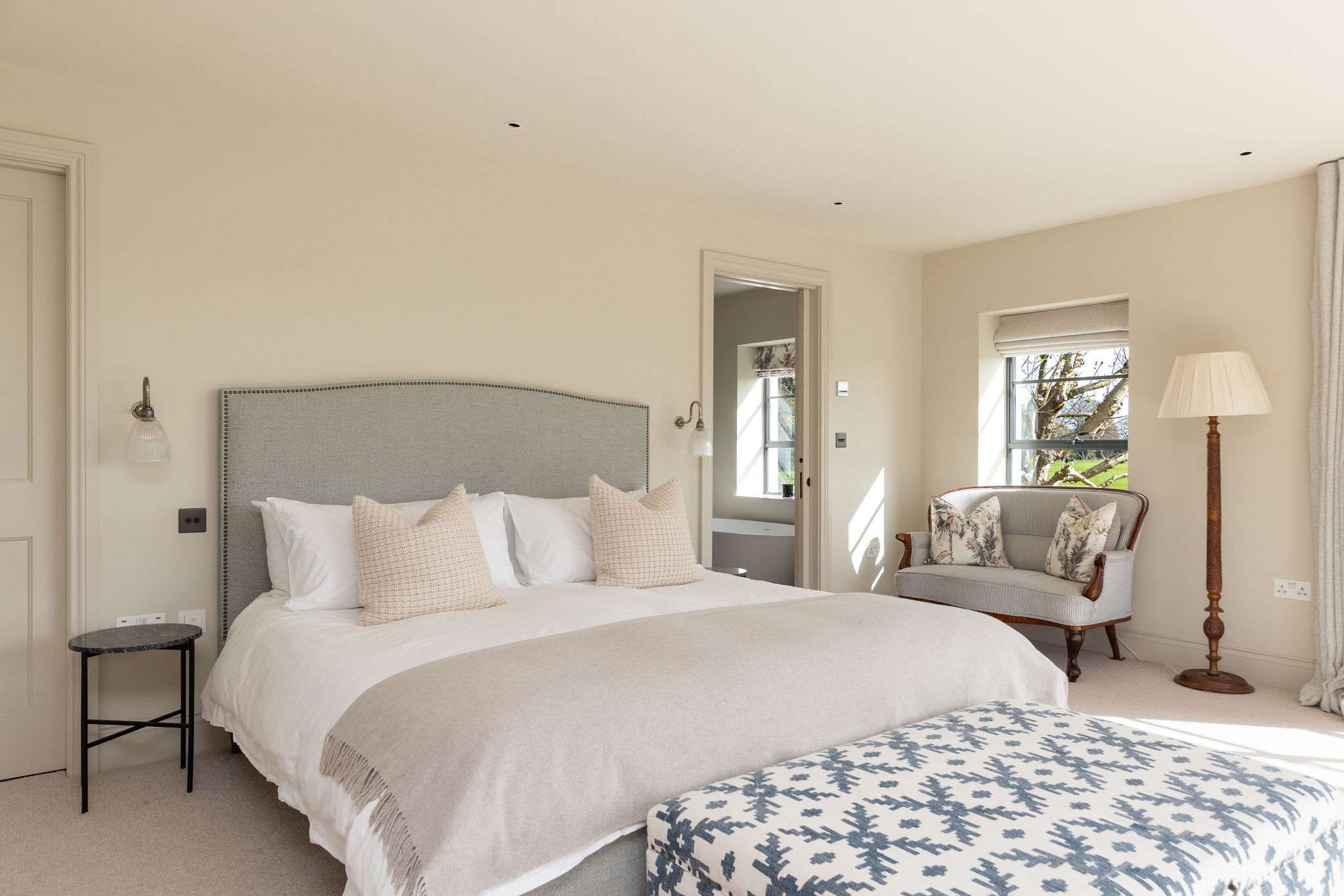 Restful king bedroom with plush bedding and soft furnishings for a truly peaceful stay.