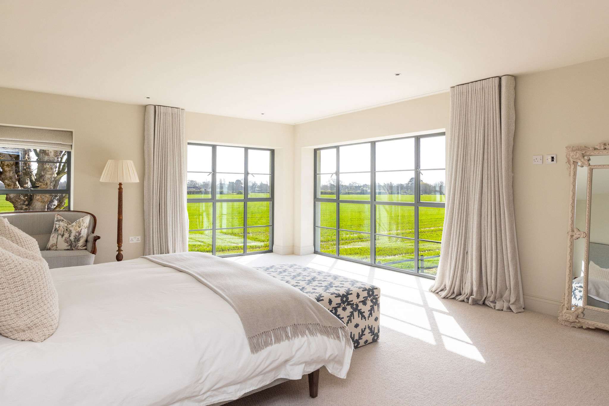 Luxurious master suite with panoramic countryside views, high-quality linens, and a private ensuite.