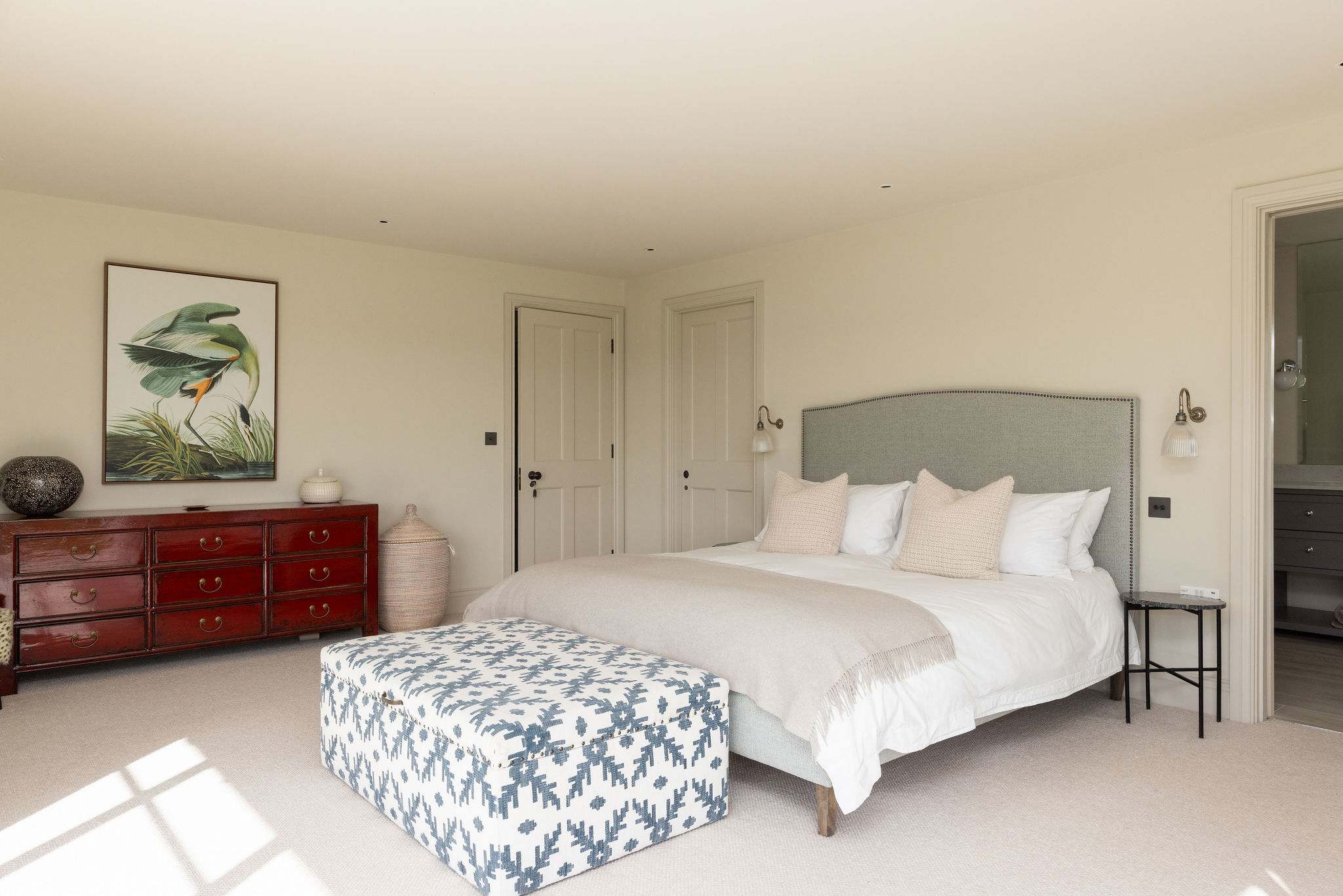 Beautifully styled bedroom blending comfort and character with quality furnishings and curated artwork.