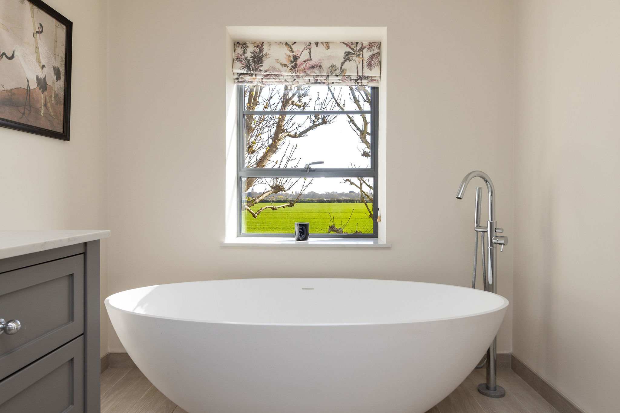 Soak in the stunning freestanding tub while enjoying peaceful countryside views through the window.
