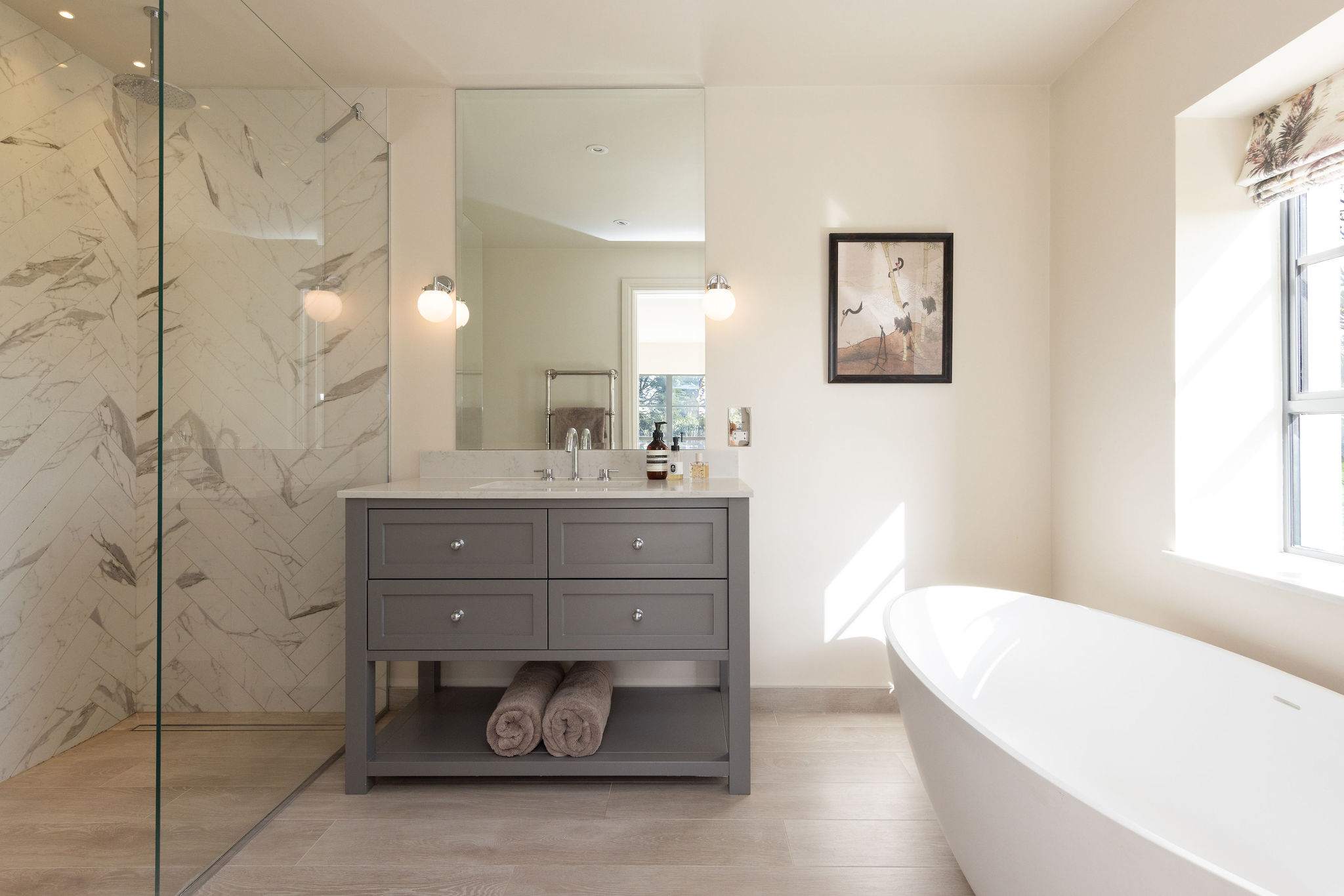 Spa-inspired bathroom featuring a freestanding bath, walk-in shower, and elegant contemporary finishes.