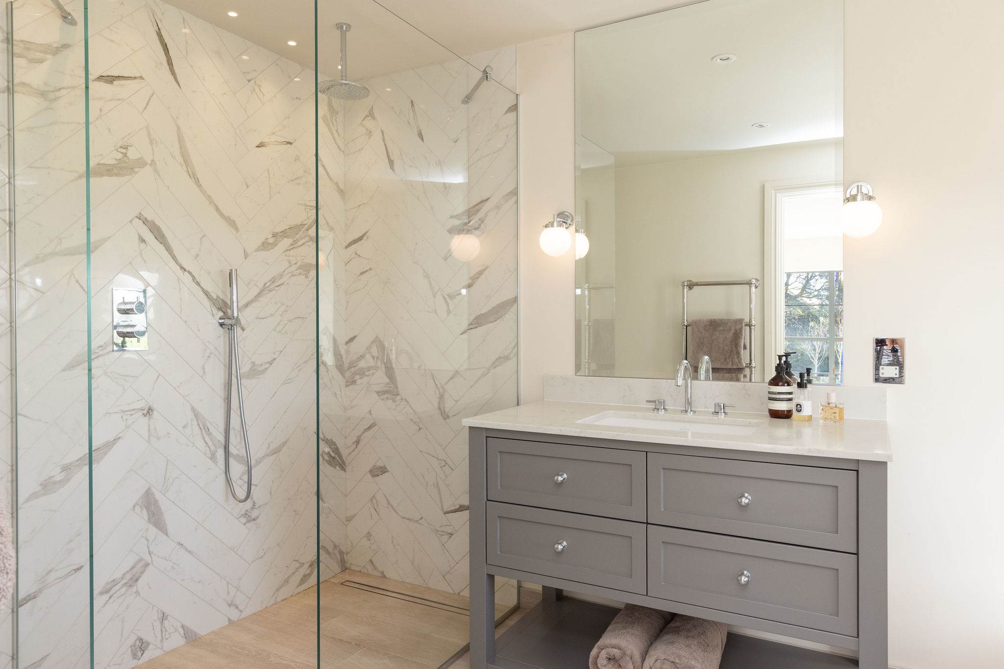 Contemporary ensuite with walk-in marble shower, stylish vanity, and modern fixtures throughout.