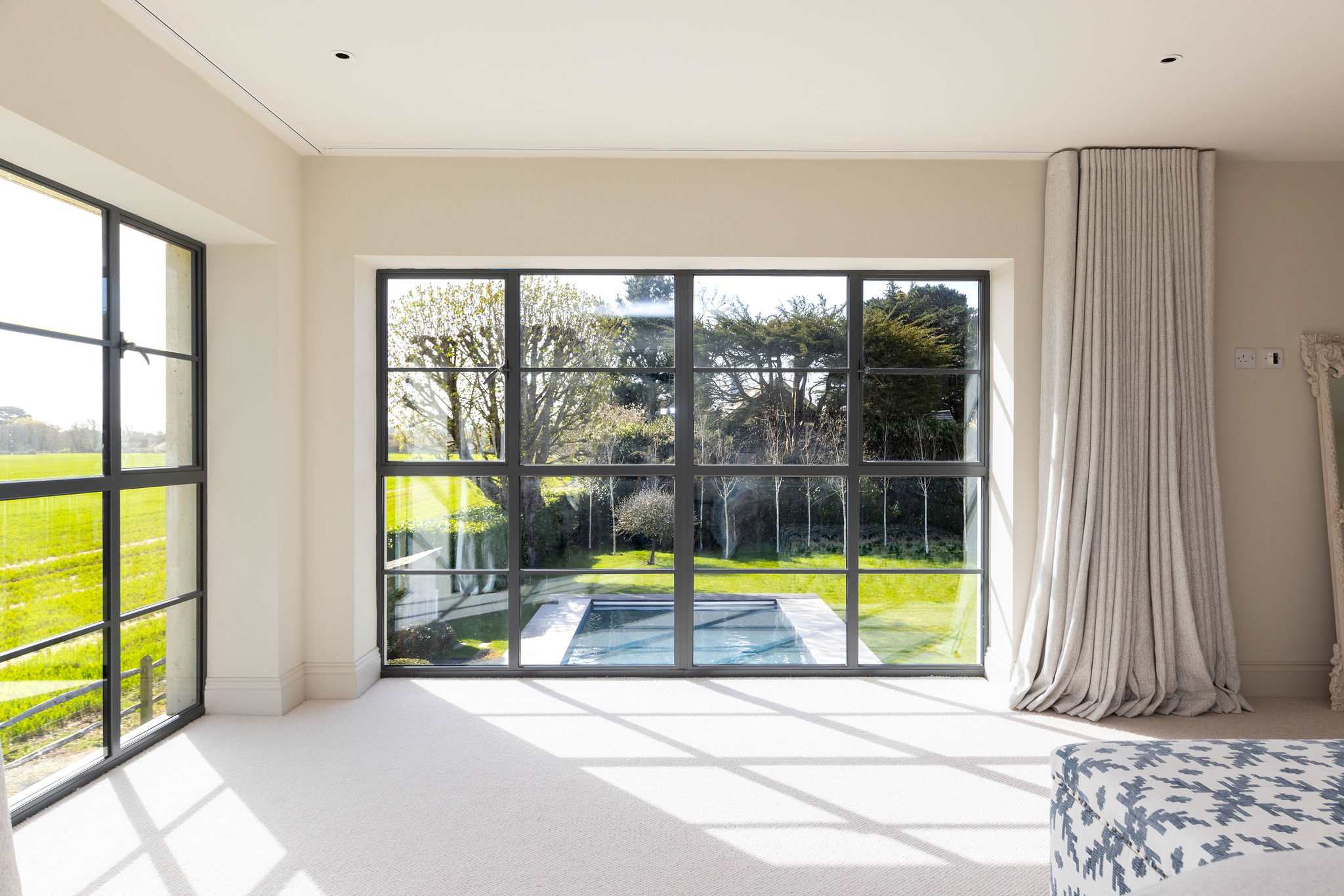 Wake up to stunning views of the heated pool and lush gardens from your bedroom.