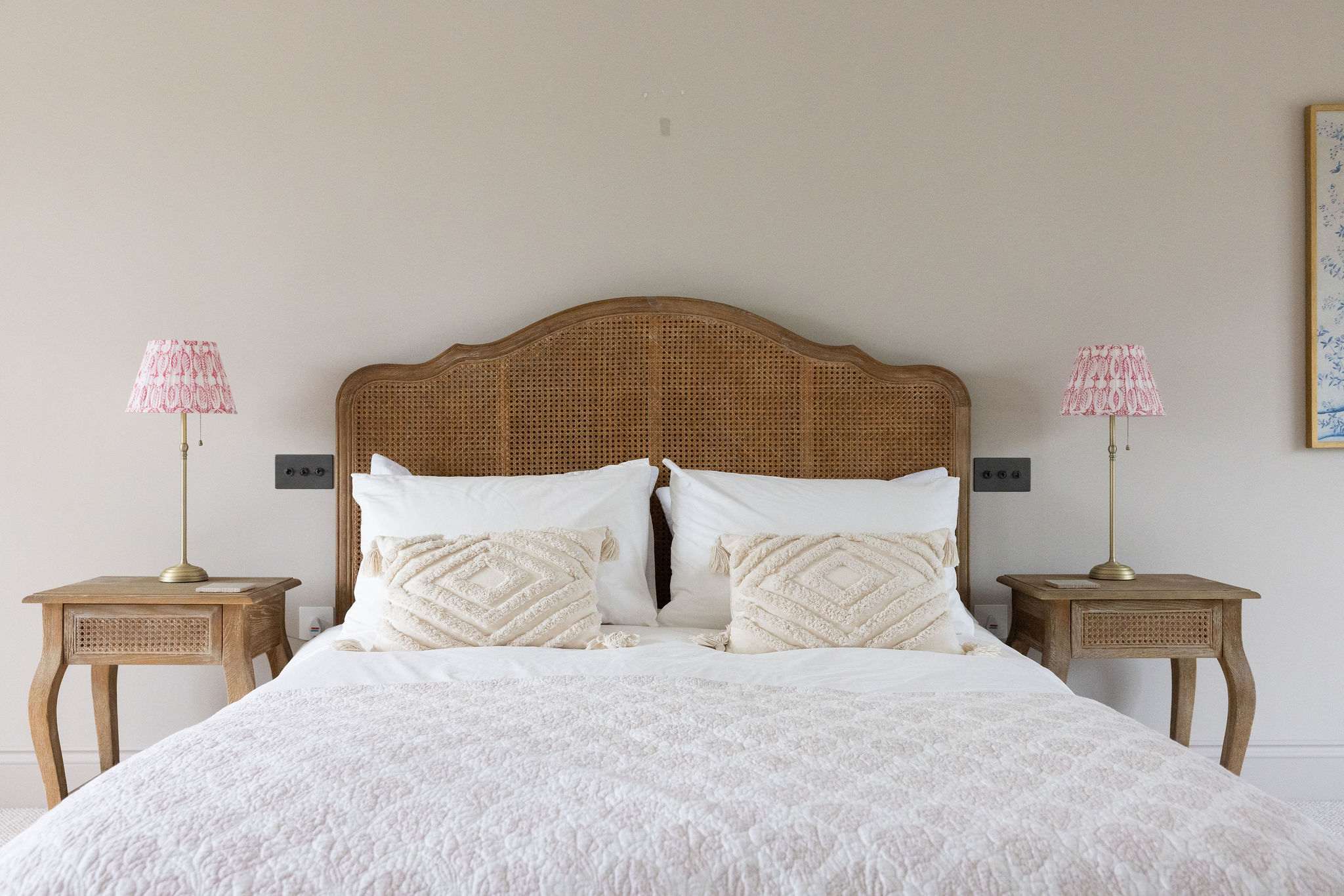 Beautiful attention to detail with textured cushions, elegant lamps, and a restful, inviting feel.