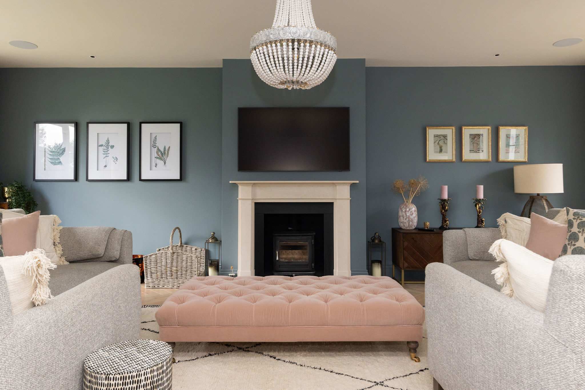 Elegant main lounge with cosy fireplace, stylish furnishings, and a serene coastal colour palette.
