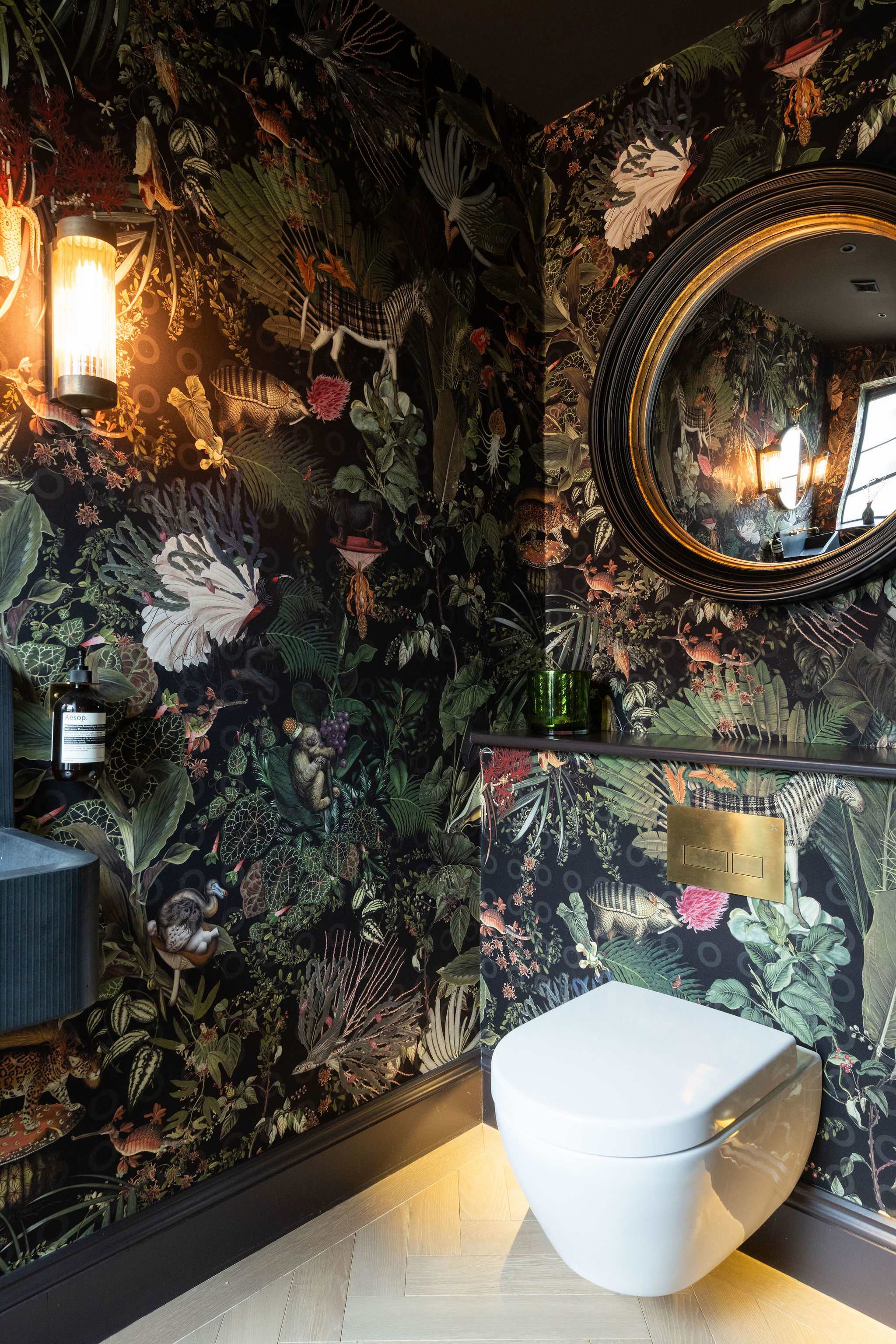 Every corner is beautifully designed — bold wallpaper and gold mirror create a memorable impression.