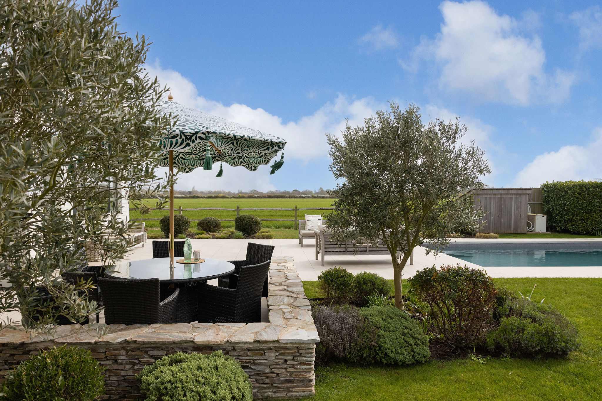Al fresco dining among olive trees and landscaped gardens with the pool just steps away.