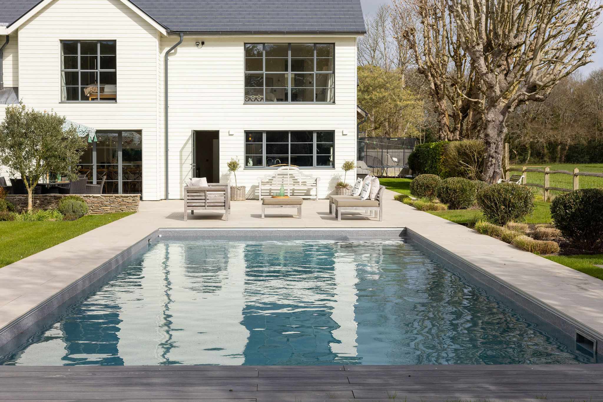 Impressive exterior with heated pool, stylish outdoor seating, and a stunning architectural backdrop.