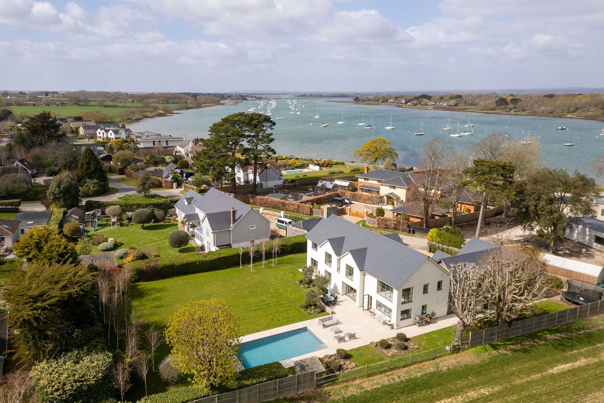 Proudly set along Chichester Harbour with pool, gardens, and stunning waterside views all around.