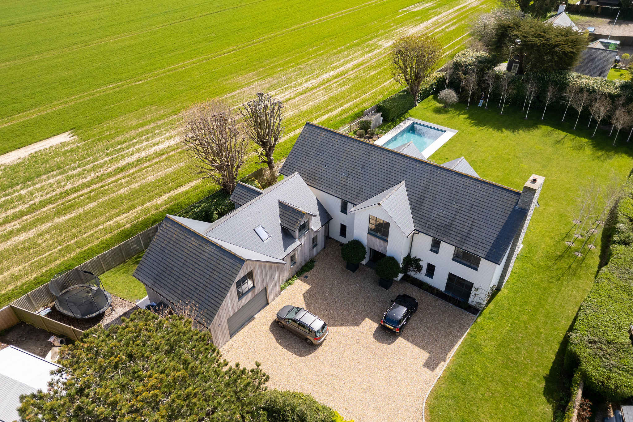 Aerial perspective showing the stunning property with private parking, pool, and countryside surroundings.