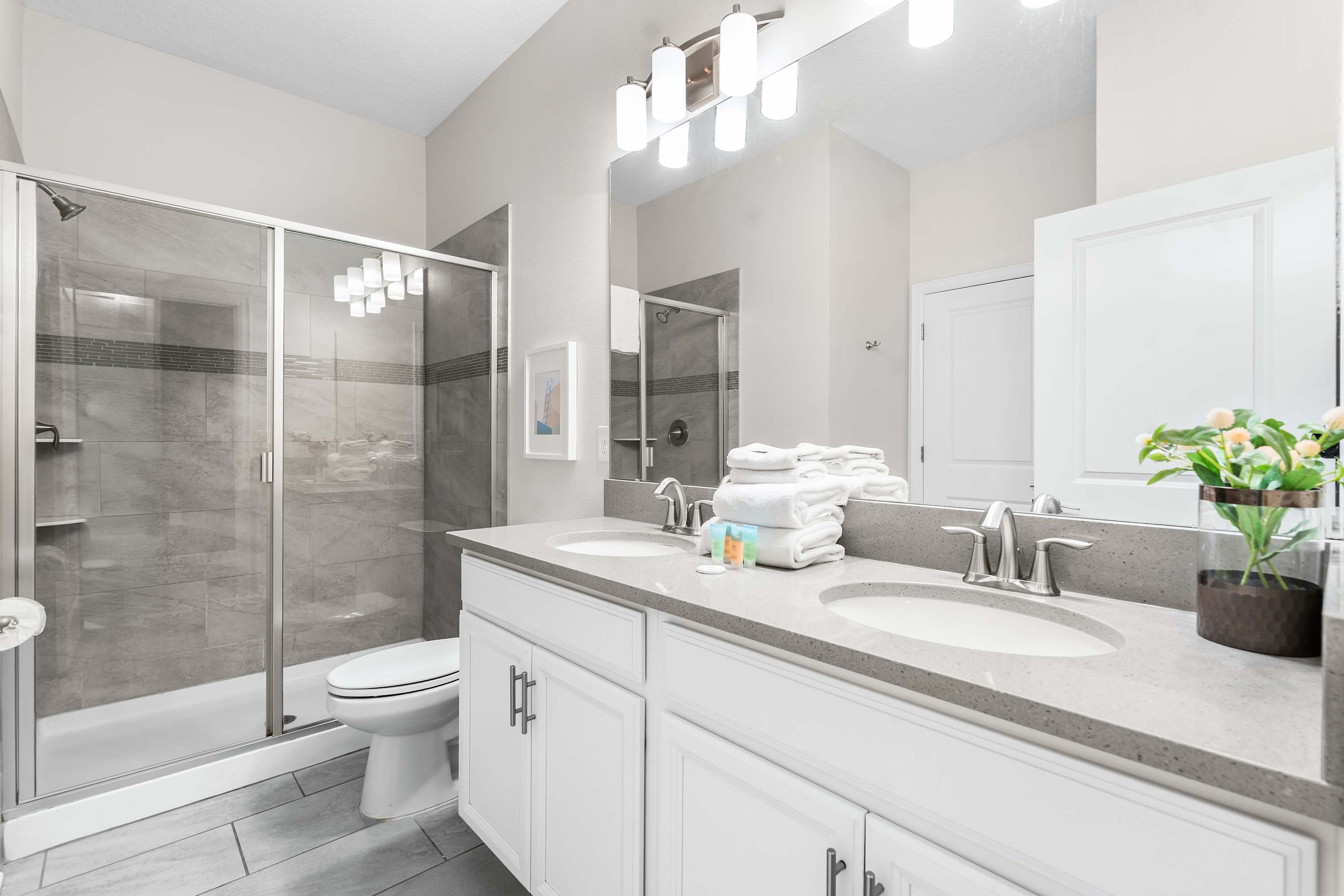 Spacious bathroom with extended vanity and ample counter space for added comfort.