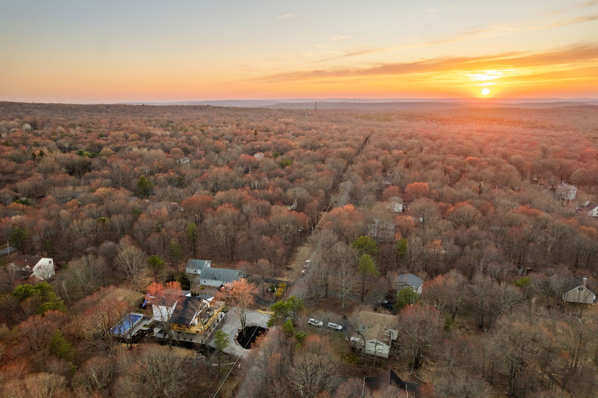 Golden sunset over the Pocono treetops with the property tucked in the woods