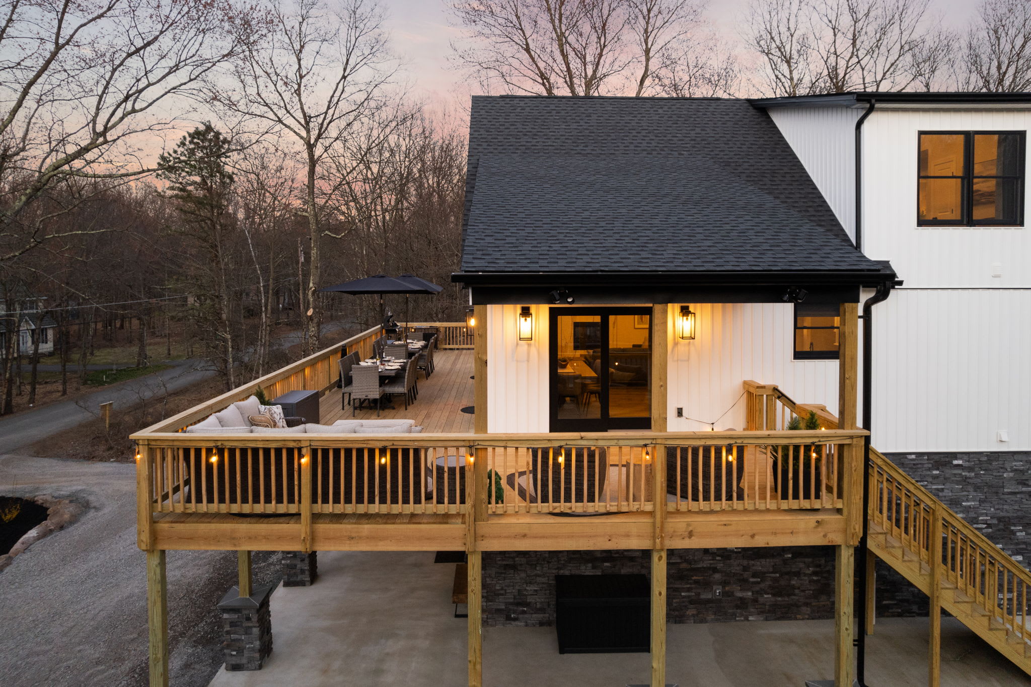 Welcoming exterior view at dusk with deck lights warming the entrance