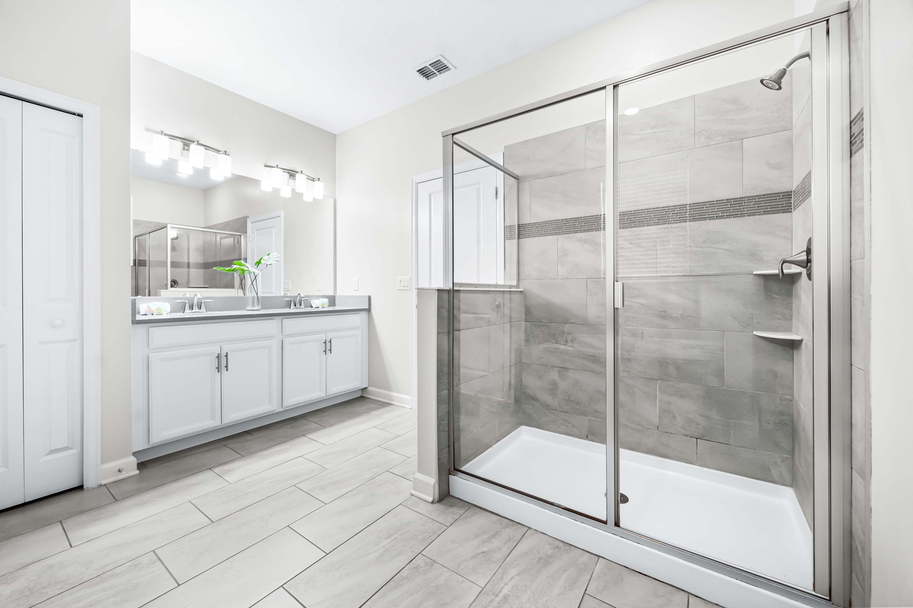 Full bathroom with glass-enclosed shower and clean finishes.