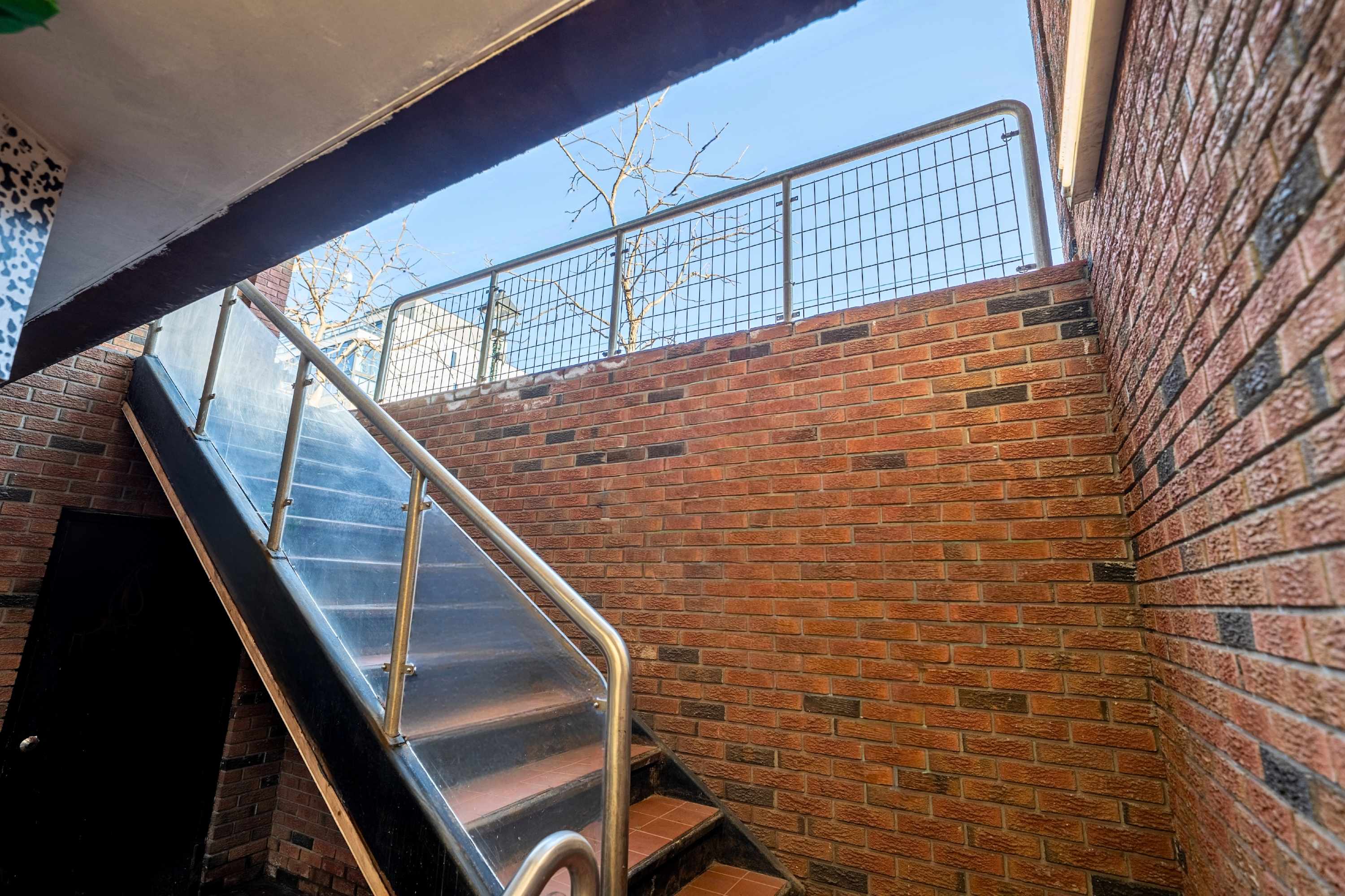 Stair access leading to a fully private unit.