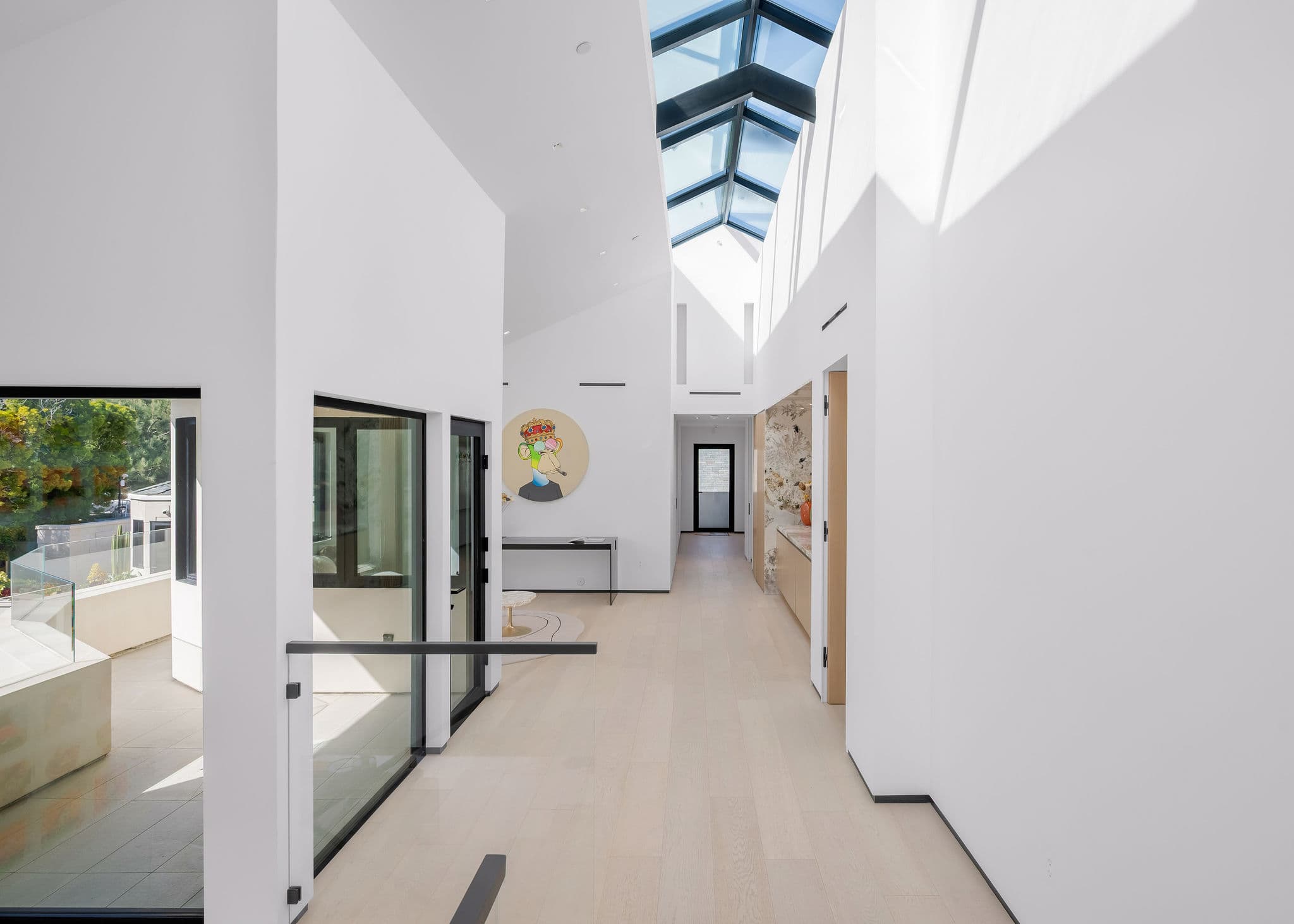 Walk through a light-filled hallway beneath a full-length skylight feature.