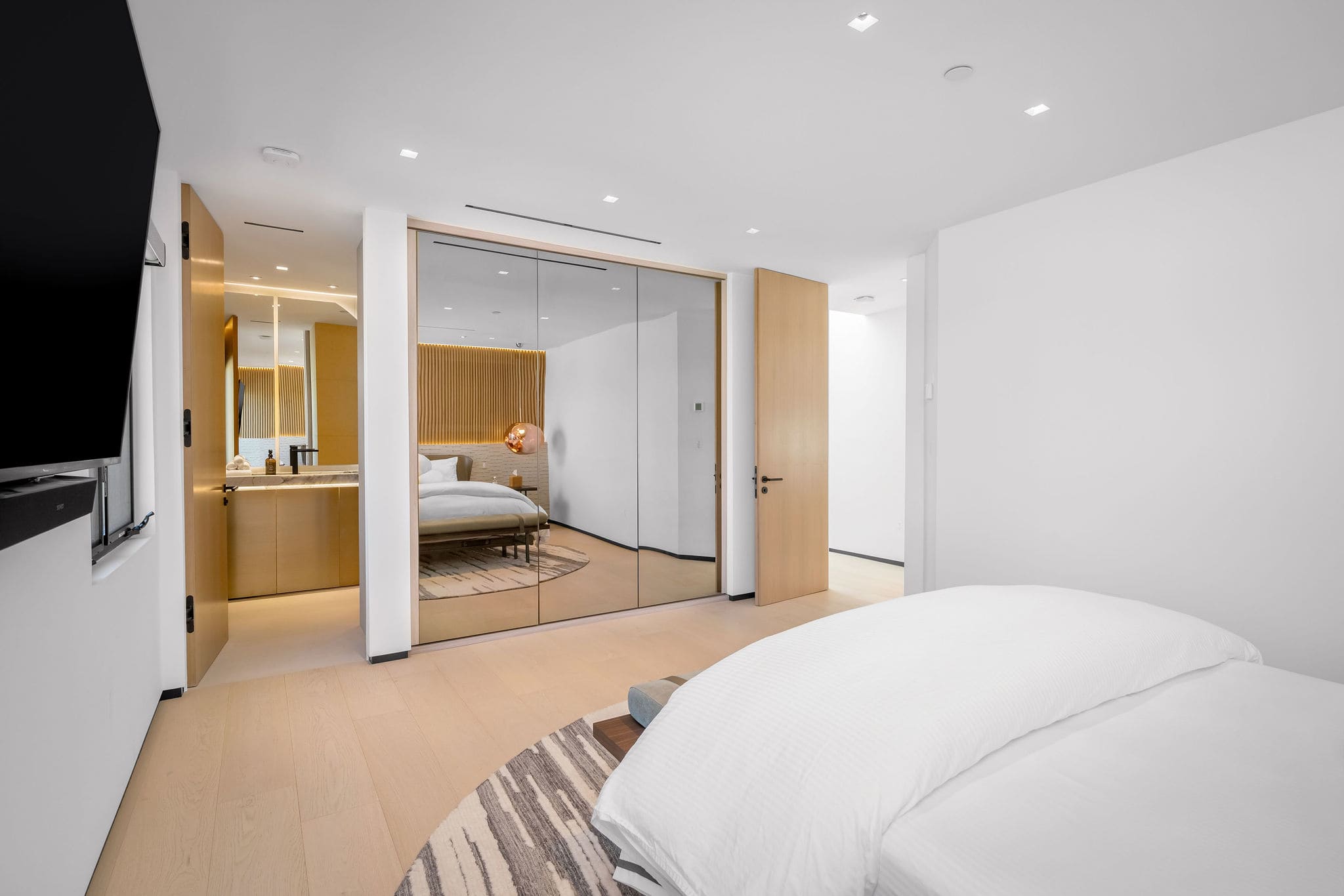 Rest in a bedroom suite framed by wood paneling with the TV positioned for bed.