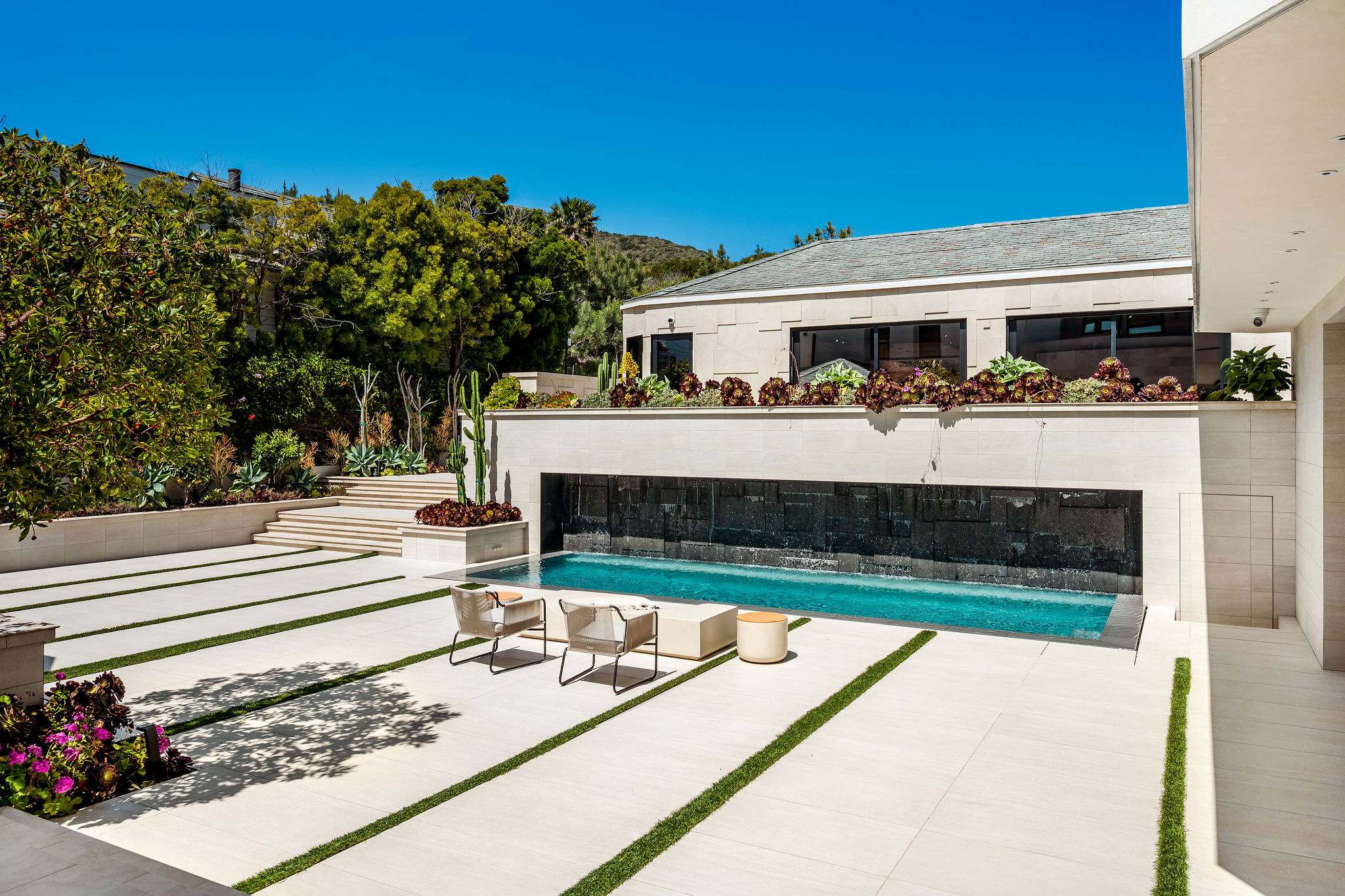 Spend time around the courtyard pool with the water feature running the full length beside you.