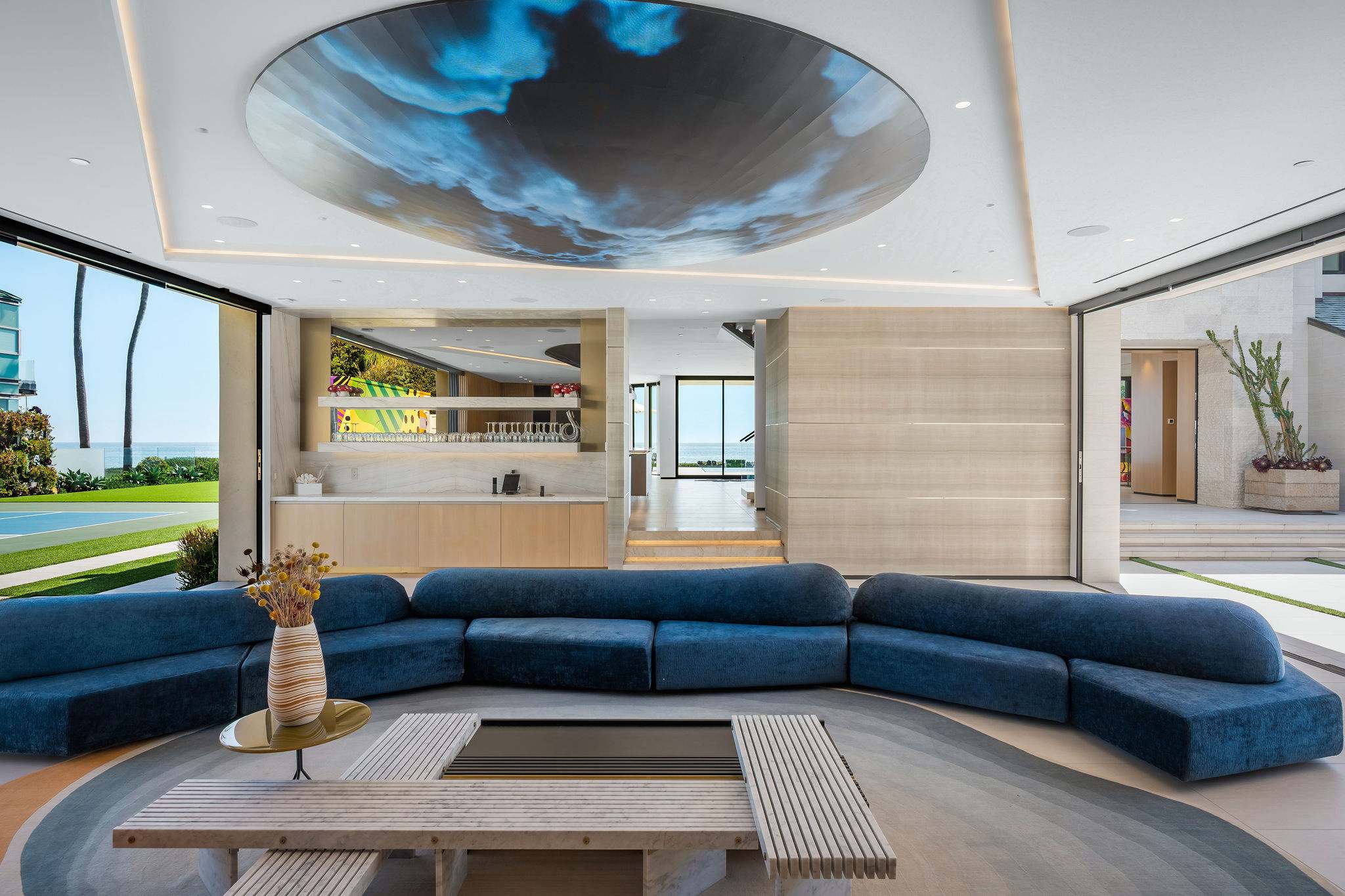 Settle into the media lounge, with wraparound seating and the full space opening just beyond.