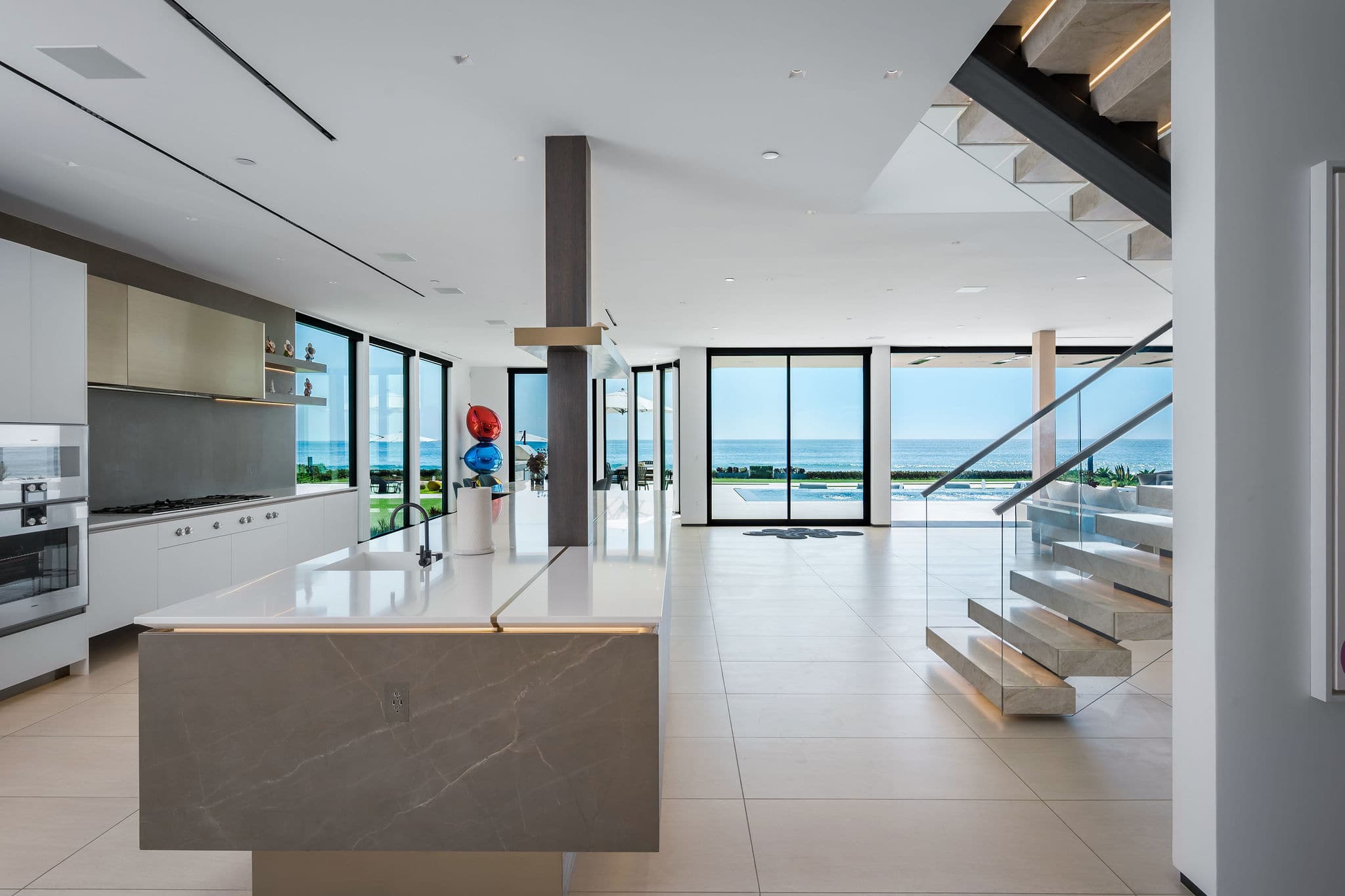 Move through the kitchen and up the stairs with ocean views following you throughout.