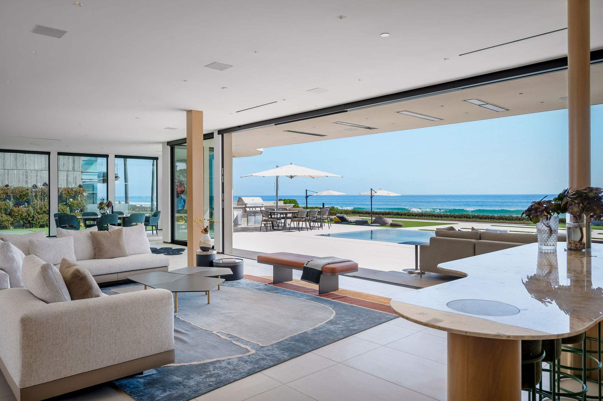 Move from the lounge to the bar and straight out to the pool, with the oceanfront just beyond.