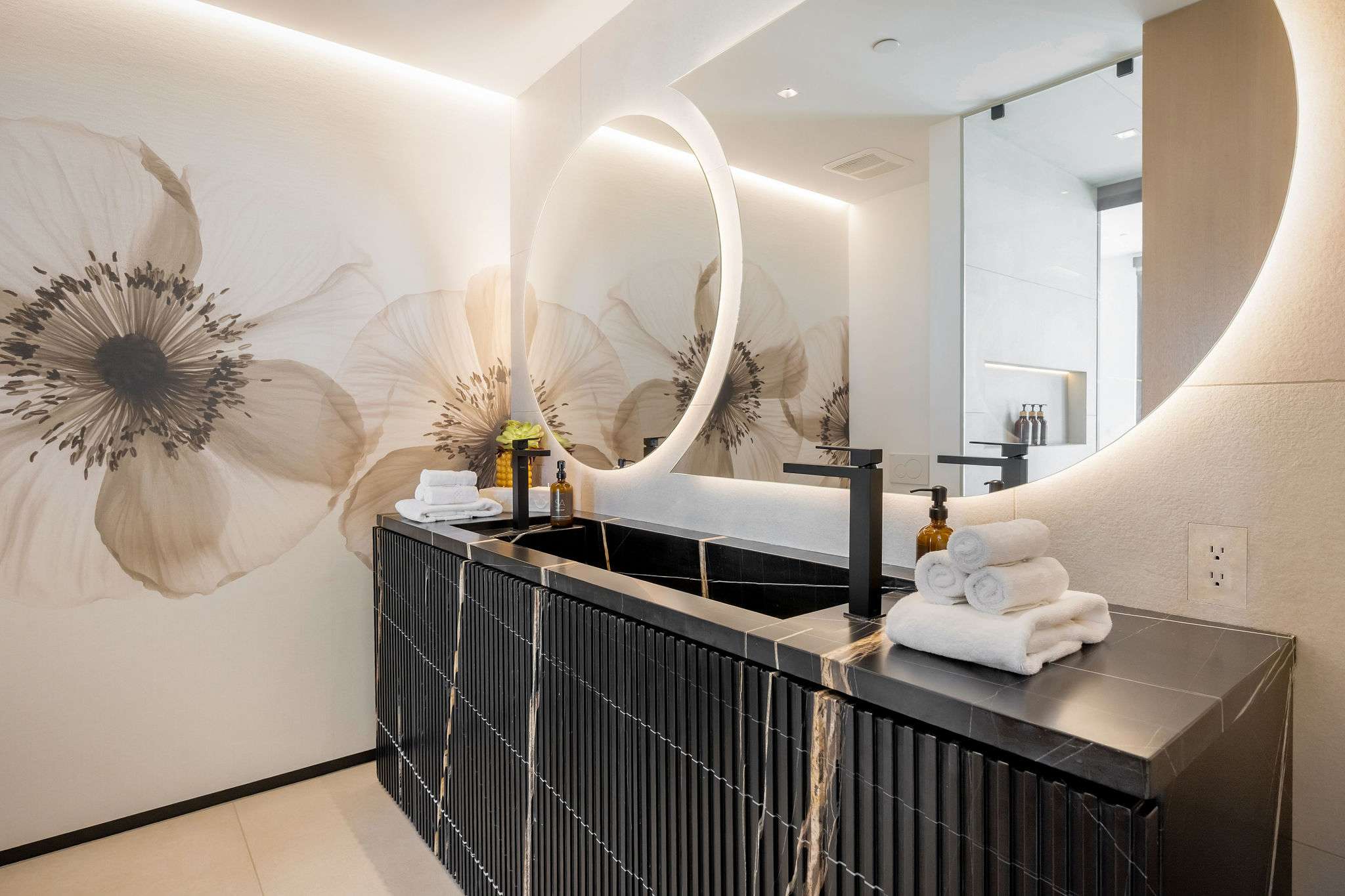 Designer powder room with statement vanity and custom wall finishes.