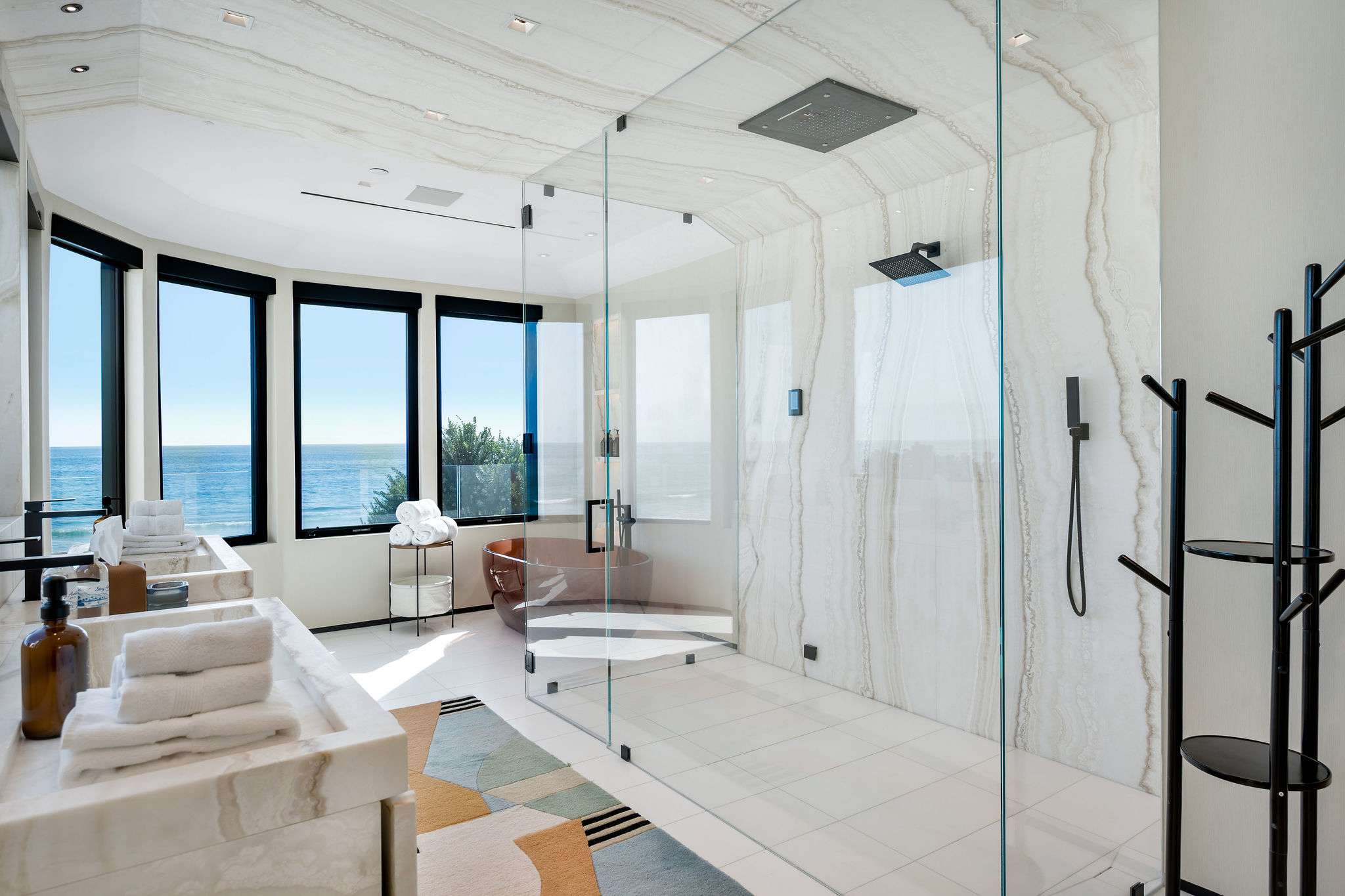 Start and end the day with ocean views, with the shower and bath set along the glass.