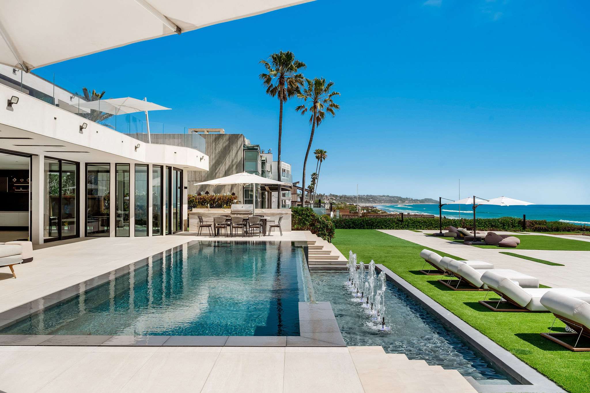 Swim alongside the infinity-edge pool with the oceanfront running the full length beside you.