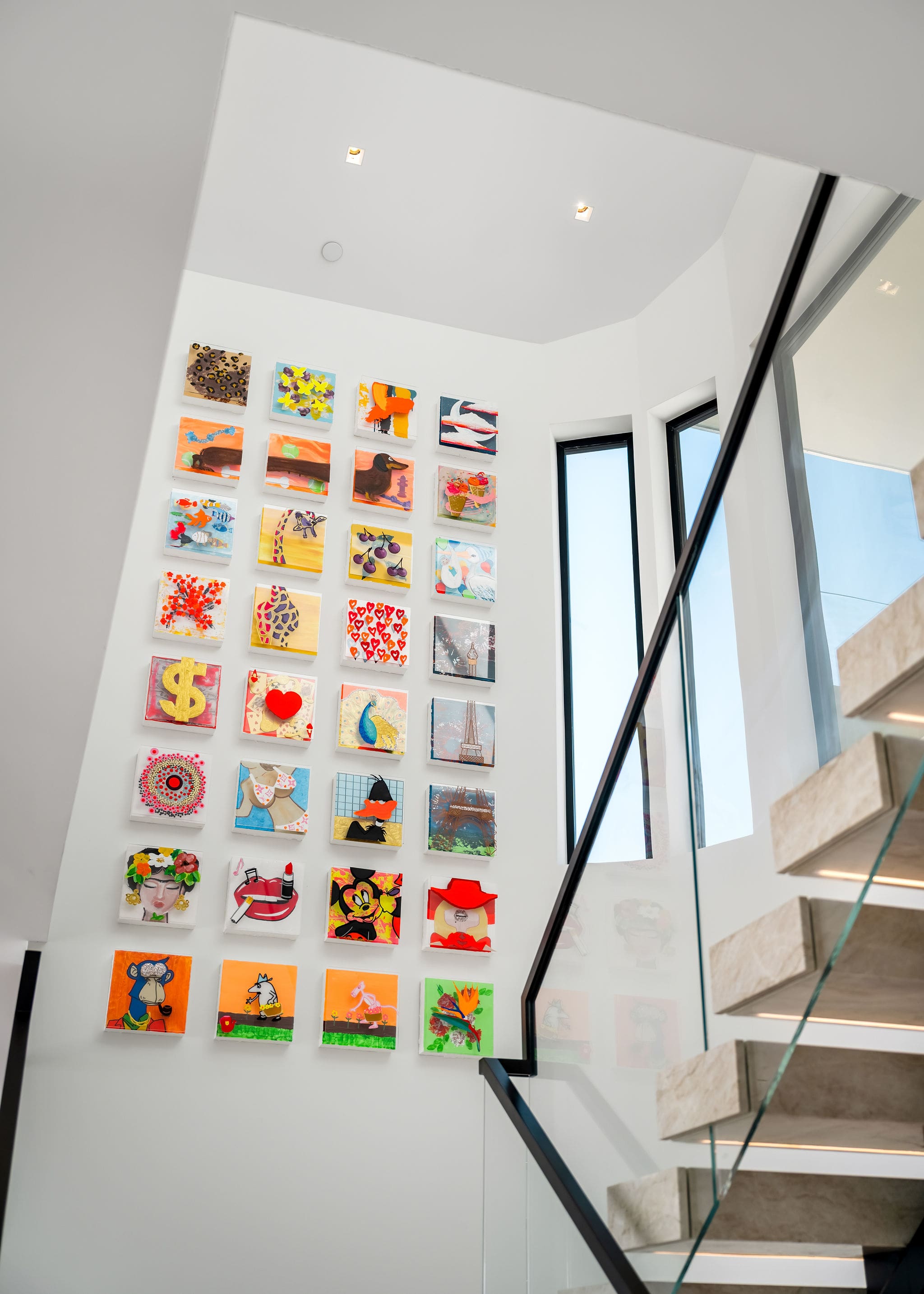 Pass through a light-filled stairwell framed by a full-height gallery wall.
