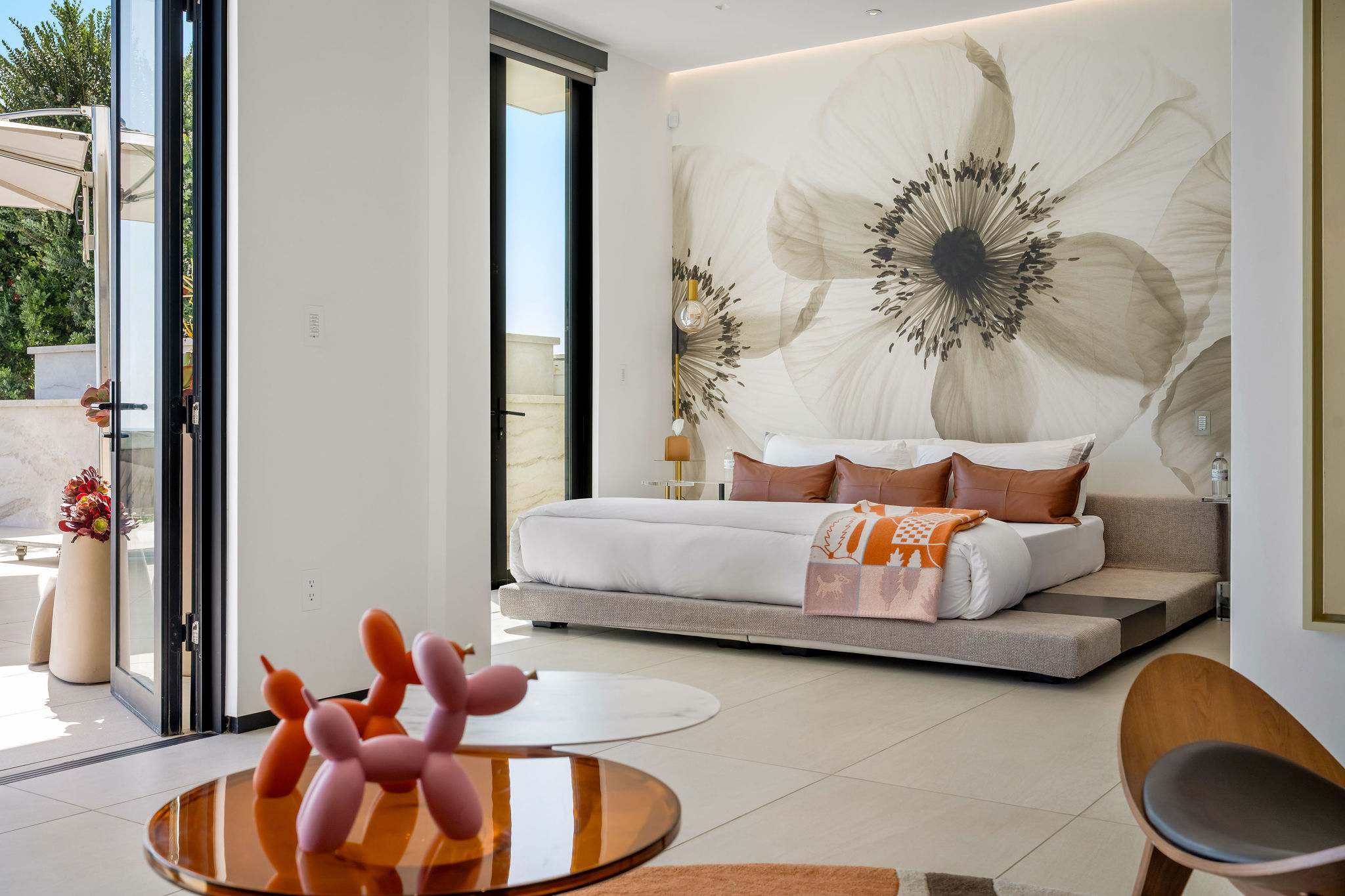 A bedroom space with artwork and essentials positioned within easy reach.