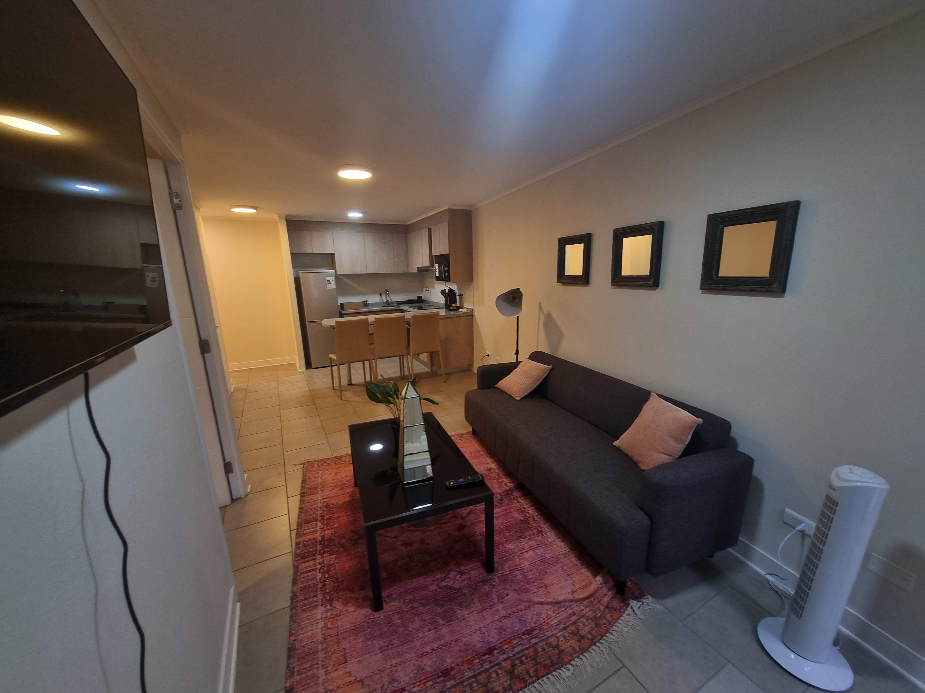 Cozy living area with modern amenities and a stylish kitchen, perfect for a relaxing stay in the heart of the city.