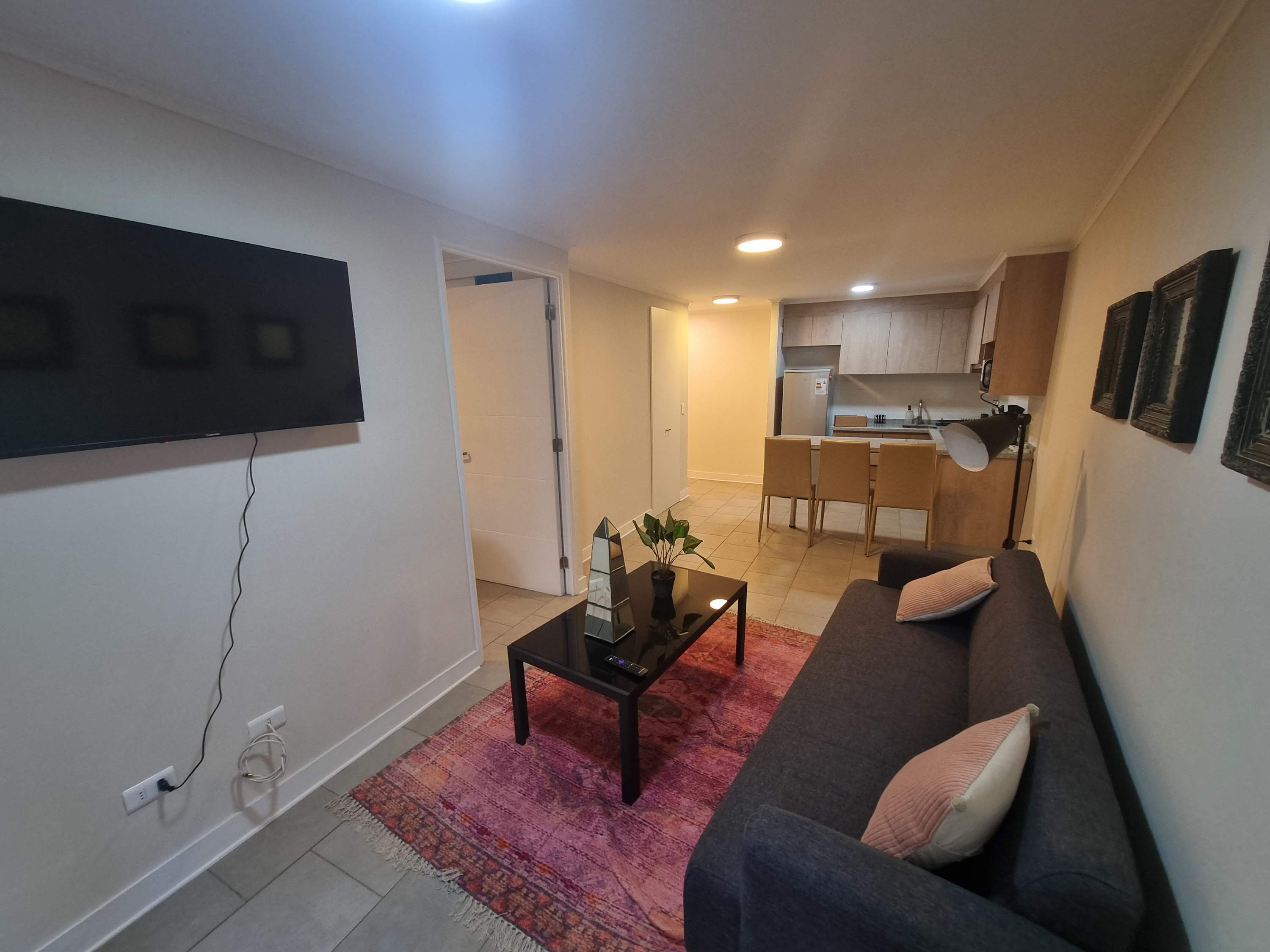 Cozy living area with modern amenities and a stylish kitchen, perfect for a relaxing stay.