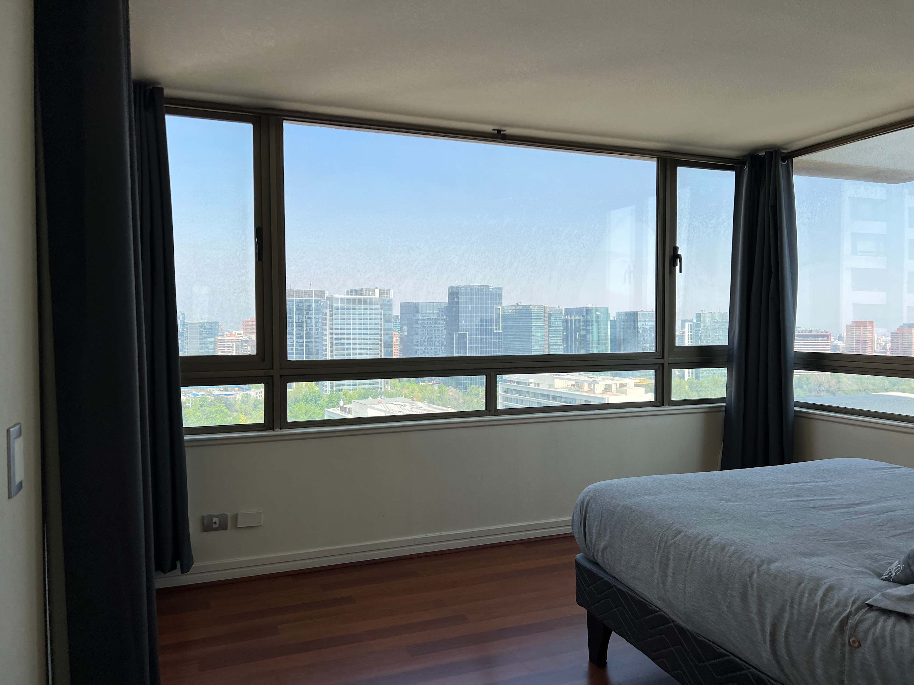 Wake up to stunning city views from this cozy bedroom, perfect for a relaxing stay in the heart of the city.