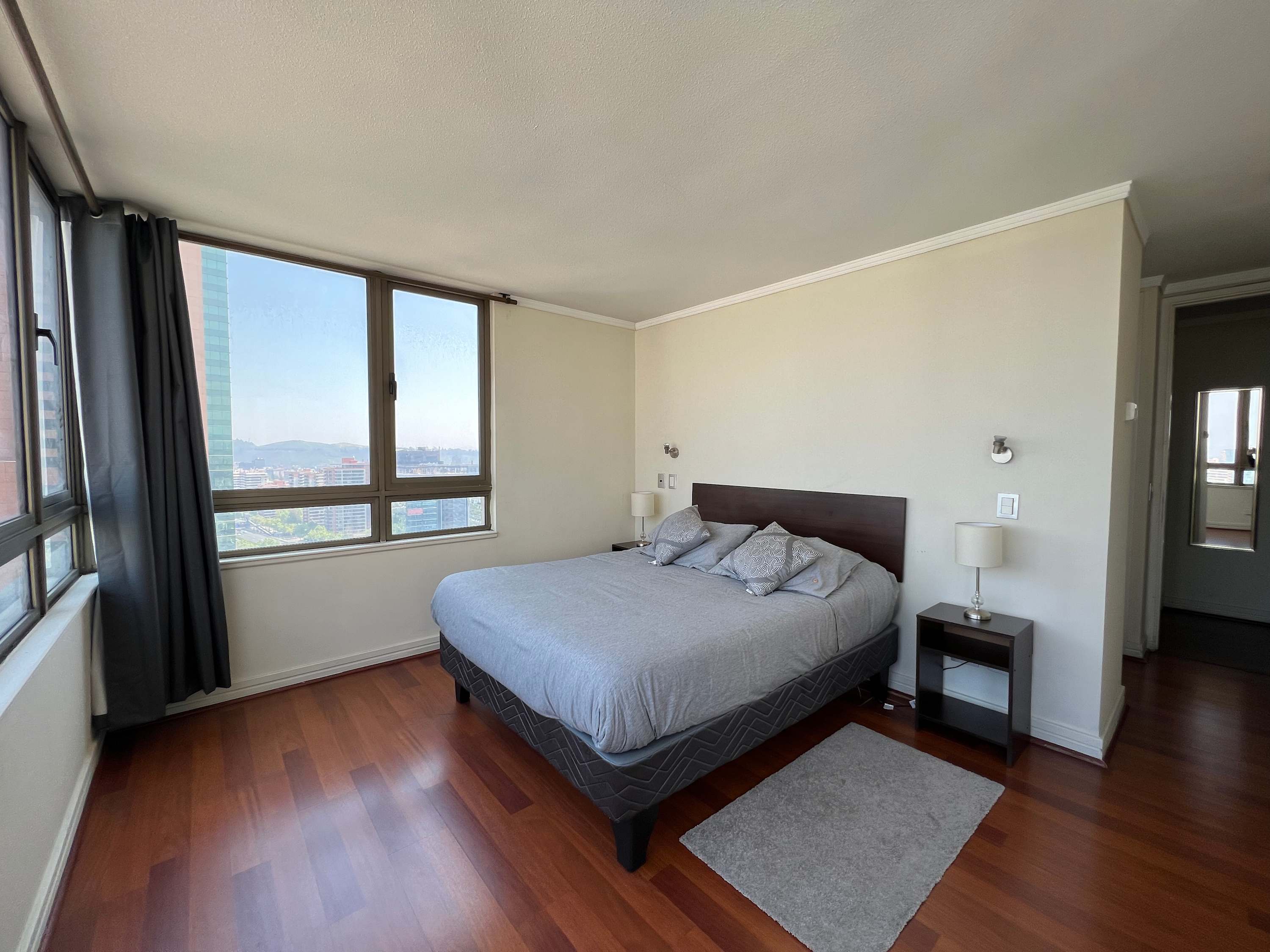 Relax in this cozy bedroom with stunning city views, perfect for unwinding after a day of exploring.