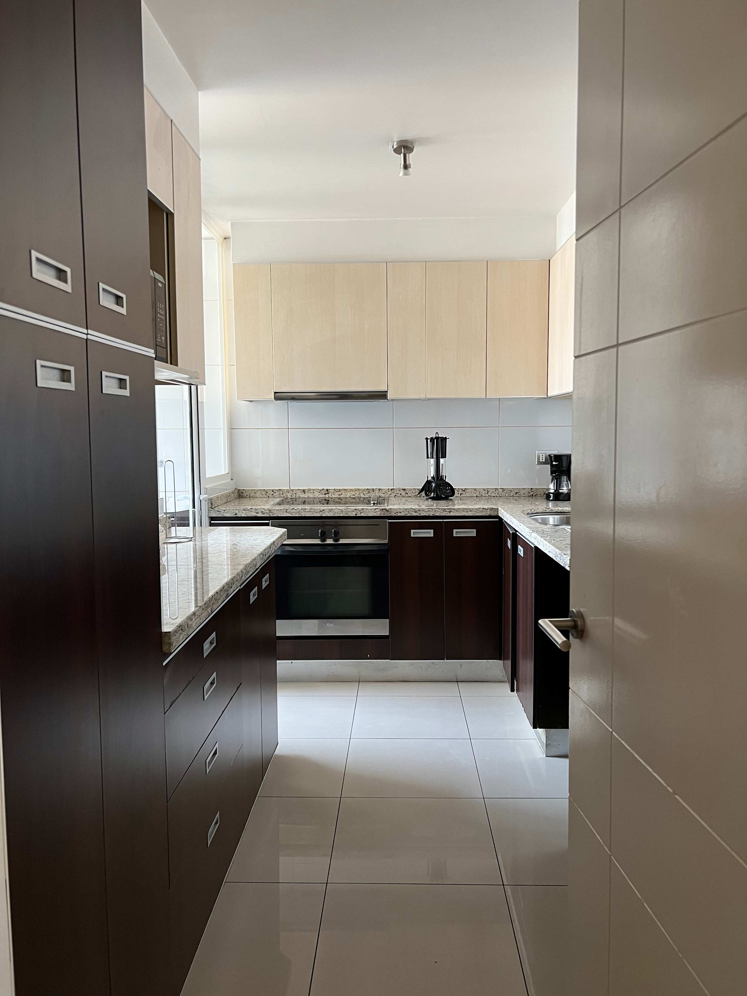 Sleek and modern kitchen with granite countertops and stainless steel appliances, perfect for culinary enthusiasts.
